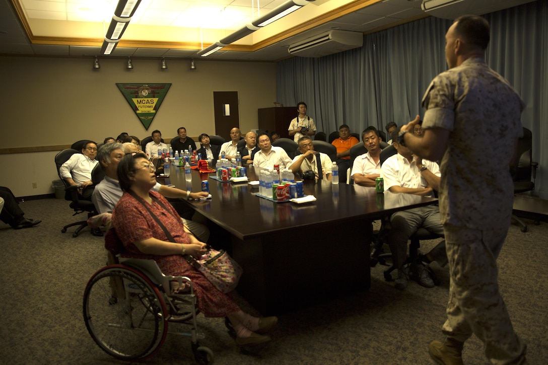 Members of the Okinawa Prefecture Defense Association listen to Col. Peter Lee’s response during the question and answer portion of an educational tour Oct. 22 on Marine Corps Air Station Futenma, Okinawa, Japan. Lee explained to guests the mission of tenant units on MCAS Futenma and highlighted the Marines’ contribution to the Okinawa community as well as disaster relief efforts and operational capabilities of the air station throughout the Asia-Pacific region. Lee is the commanding officer of MCAS Futenma, Marine Corps Installations Pacific and a New Rochelle, N.Y., native.
