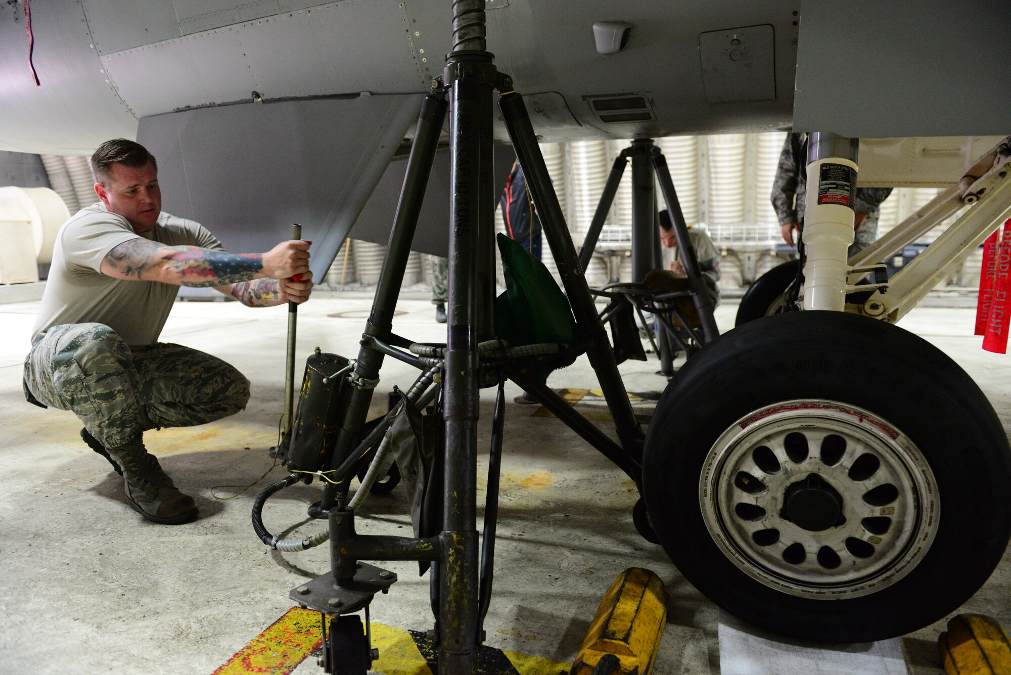 Staff Sgt. James McFadden, 35th Maintenance Group quality assurance manager, positions an aircraft jack beneath the wing of an F-16 Fighting Falcon during a weight and balance check class at Osan Air Base, Republic of Korea, Oct. 14, 2015. The class trained ROK and U.S. quality assurance managers how to properly weigh and balance aircraft using specialized systems. 
(U.S. Air Force photo/Staff Sgt. Amber Grimm)