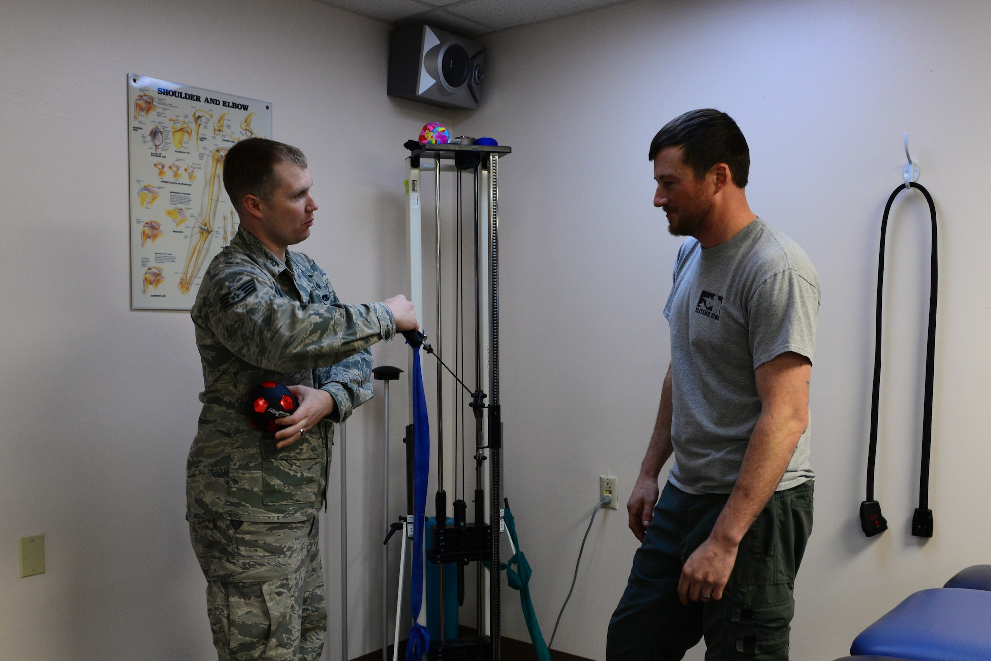 U.S. Air Force Staff Sgt. Michael White, a 354th Medical Group physical therapy technician, demonstrates an exercise to Staff Sgt. Barret Chappelle, a 354th Security Forces Squadron military working dog handler, Oct. 22, 2015, at Eielson Air Force Base, Alaska. White demonstrates all exercises to his patients before they do them on their own. (U.S. Air Force photo by Airman 1st Class Cassandra Whitman/Released)