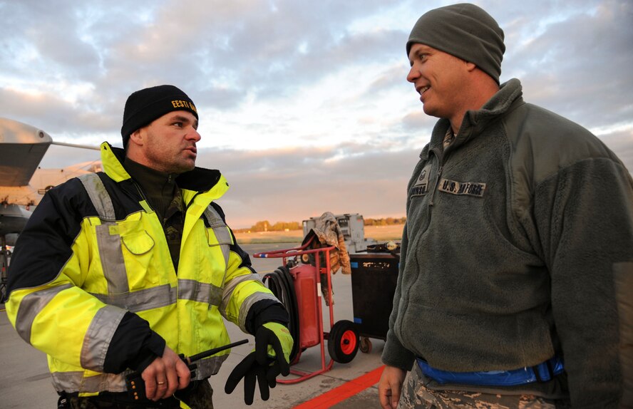 Estonian air force maintainers work together to deice the wing of an 74th Expeditionary Fighter Squadron A-10 Thunderbolt II attack aircraft assigned to the 23d Wing at Moody Air Force Base, Georgia, on the flightline at Amari Air Base, Estonia, Oct. 8, 2015. The operation was the first time the Estonian maintainers used the deicing equipment outside of training. (U.S. Air Force photo by Andrea Jenkins/Released)