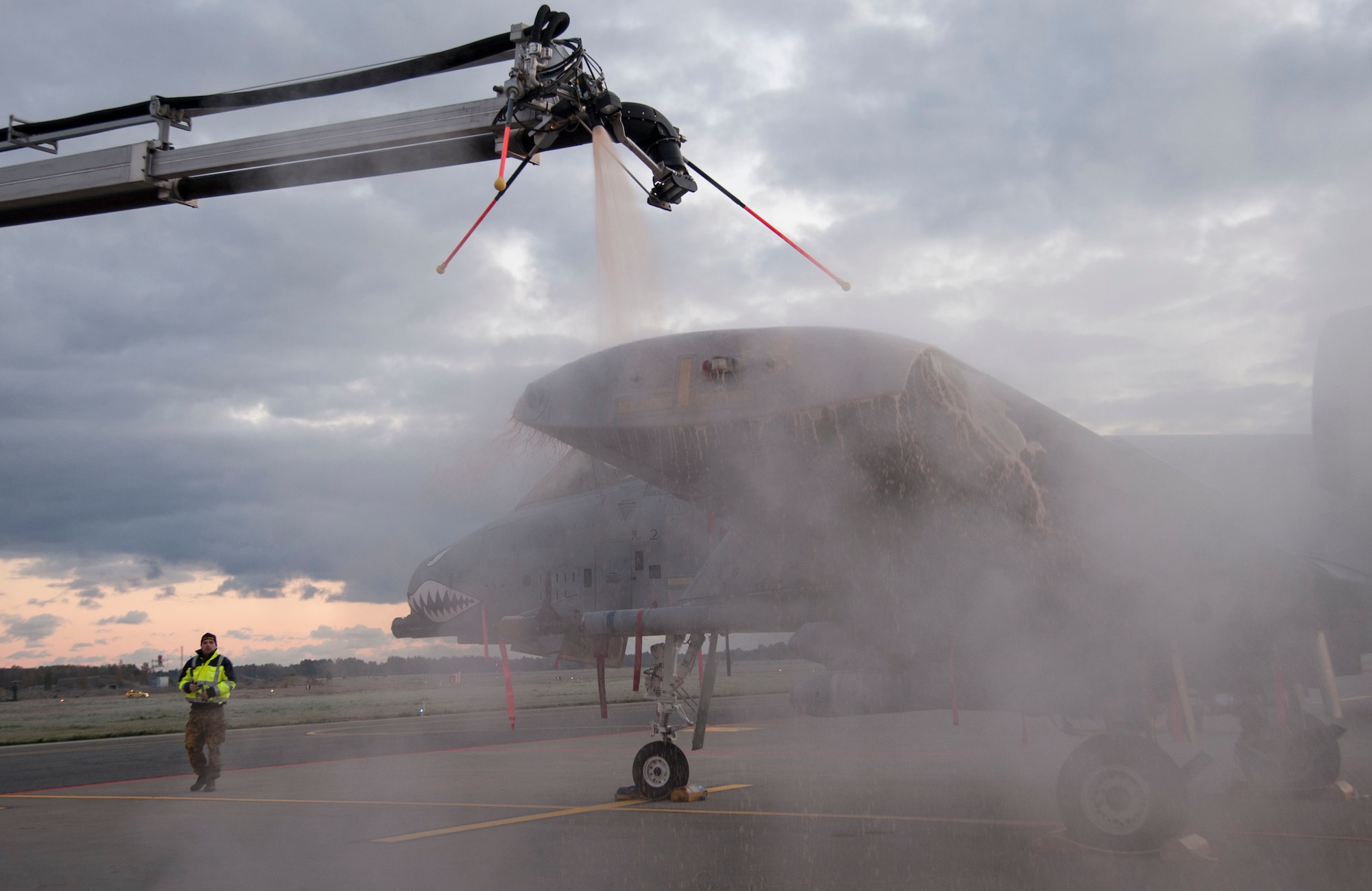 Estonian air force maintainers work together to deice the wing of a 74th Expeditionary Fighter Squadron A-10 Thunderbolt II attack aircraft assigned to the 23d Wing at Moody Air Force Base, Georgia, on the flightline at Amari Air Base, Estonia, Oct. 8, 2015. The operation was the first time the Estonian maintainers used the deicing equipment outside of training. (U.S. Air Force photo by Andrea Jenkins/Released)
