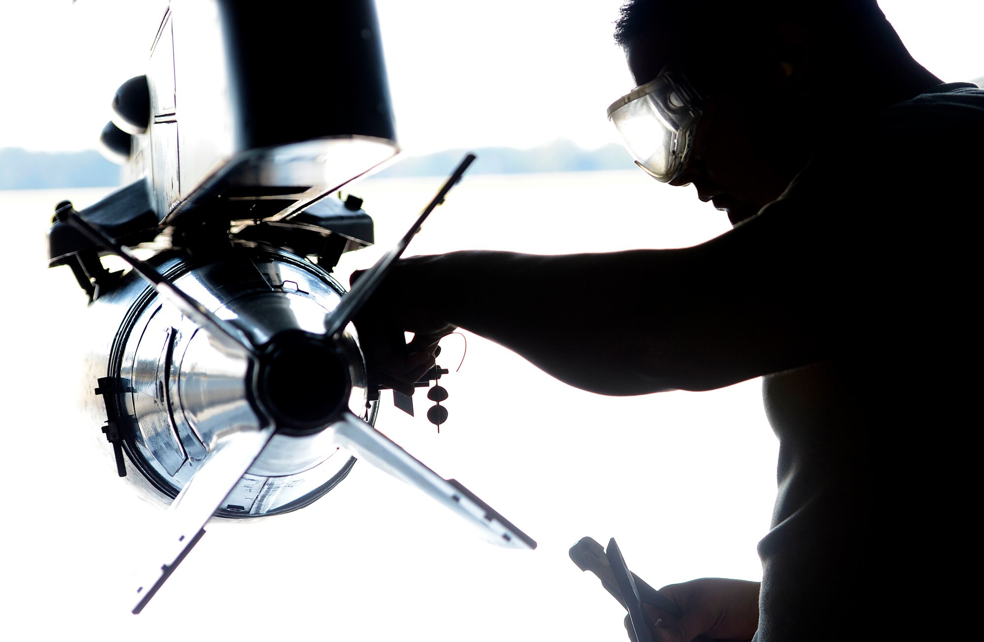 A U.S. Air Force Airman assigned to the 20th Aircraft Maintenance Squadron, 79th Aircraft Maintenance Unit, loads an MK82 LD bomb onto an F-16CM Fighting Falcon during a weapons load crew of the quarter competition at Shaw Air Force Base, S.C., Oct. 16, 2015. The three teams competing for the title loaded the AIM-9X missile, BRU-61 bomb, and MK82 LD bomb to determine which team most accurately loaded the munitions the fastest. (U.S. Air Force photo by Senior Airman Jensen Stidham/Released) 