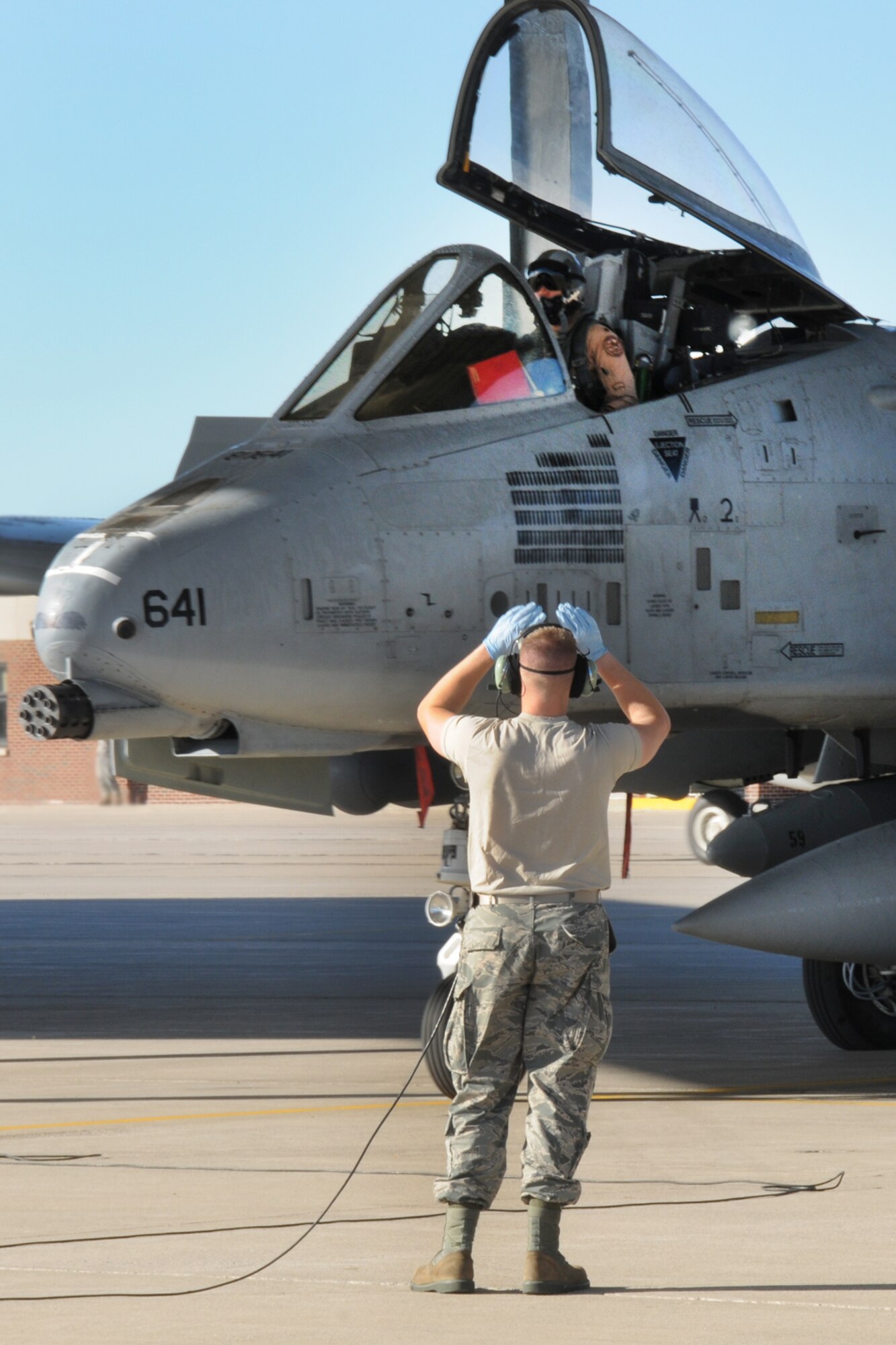 151022-Z-YW189-002 - -A crew chief with the 127th Aircraft Maintenance Squadron marshals an A-10 Thunderbolt II at Selfridge Air National Guard Base, Mich., after a six month deployment on October 22, 2015. The A-10 returned from a six month deployment from southwest Asia in support of U.S. Central Command’s Operations Inherent Resolve. (U.S. Air National Guard photo by Staff Sgt. Samara Taylor/Released) 