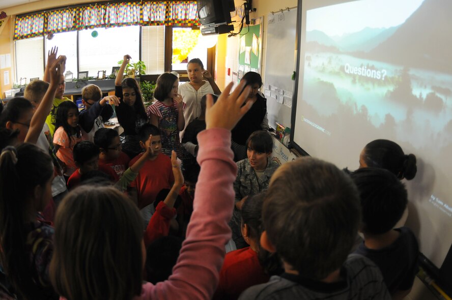 Staff Sgt. Jennifer Burgos, weather forecast specialist with the 188th Operations Support Squadron, performs a demonstration of weather patterns to students at Sutton Elementary, Fort Smith, Ark., during Career Day Oct. 9, 2015. The 188th Wing has partnered with Sutton Elementary to provide a positive influence to children within the community. (U.S. Air National Guard photo by Senior Airman Cody Martin/Released)