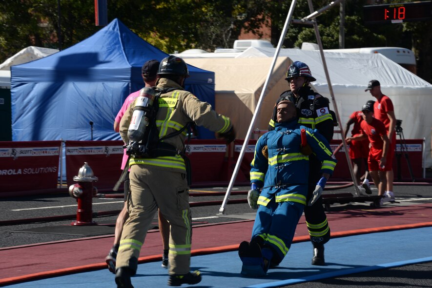 Senior Airman Scott Weeks, Maxwell fire fighter, carries a life-size 175-pound dummy to the finish line during the 2015 World Scott Fire Fighter Combat Challenge, Oct. 20, 2015, in Montgomery, Alabama. Weeks competed in the individual competition as well as the relay portion with his teammates. (U.S. Air Force photo by Airman 1st Class Alexa Culbert)