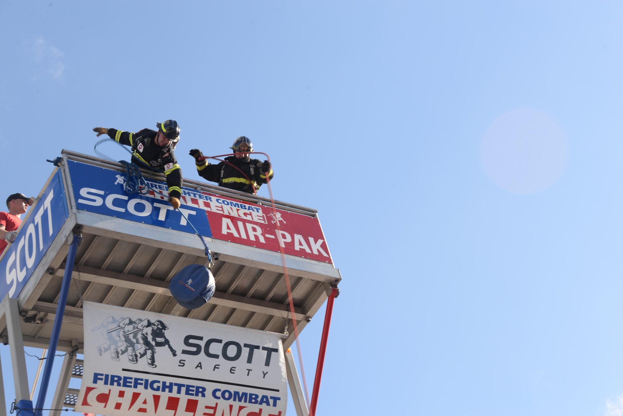 Senior Airman Scott Weeks, Maxwell fire fighter, pulls up a weight simulating hauling up a water hose during the 2015 World Scott Fire Fighter Combat Challenge, Oct. 20, 2015, in Montgomery, Alabama. Team members climbed the tower while carrying water hose before hauling up weights once at the top. (U.S. Air Force photo by Airman 1st Class Alexa Culbert)