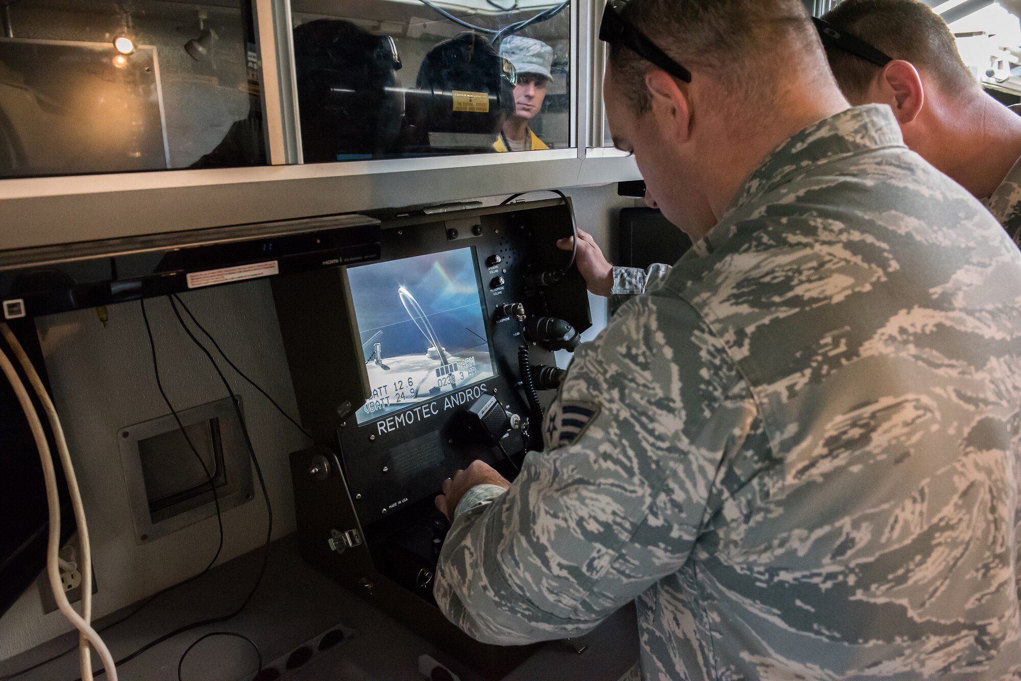 Members of the 87th Civil Engineer Squadron Explosive Ordnance Disposal team respond with a robot to a simulated suspicious package, while being evaluated by a wing inspection team member at Joint Base McGuire-Dix-Lakehurst, N.J., Oct. 20, 2015. The EOD response was in conjunction with a joint, multi-platform training exercise. (U.S. Air Force by Russell Meseroll/Released)