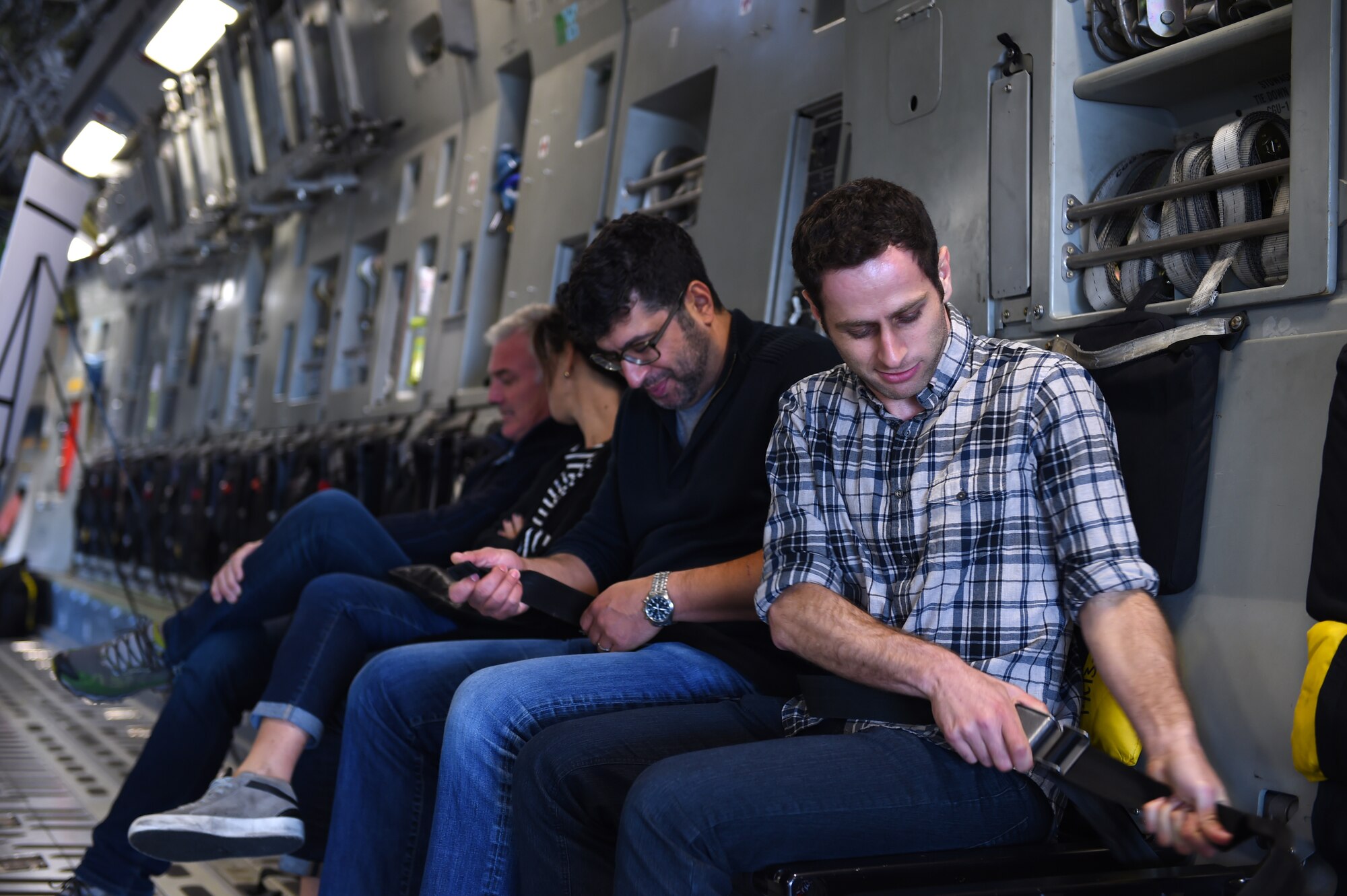 Danny Karlinsky (right), Gen Next regional director, and David Youssefnia, Gen Next member, fasten their seatbelts on a C-17 Globemaster III on the McChord Field flight line Oct. 22, 2015 at Joint Base Lewis-McChord, Wash. Gen Next, an organization of individuals dedicated to learning about the most pressing challenges facing future generations, toured the base in an effort to better understand the mission, capabilities and Soldiers and Airmen who make it happen. (Air Force Photo/Senior Airman Naomi Griego)