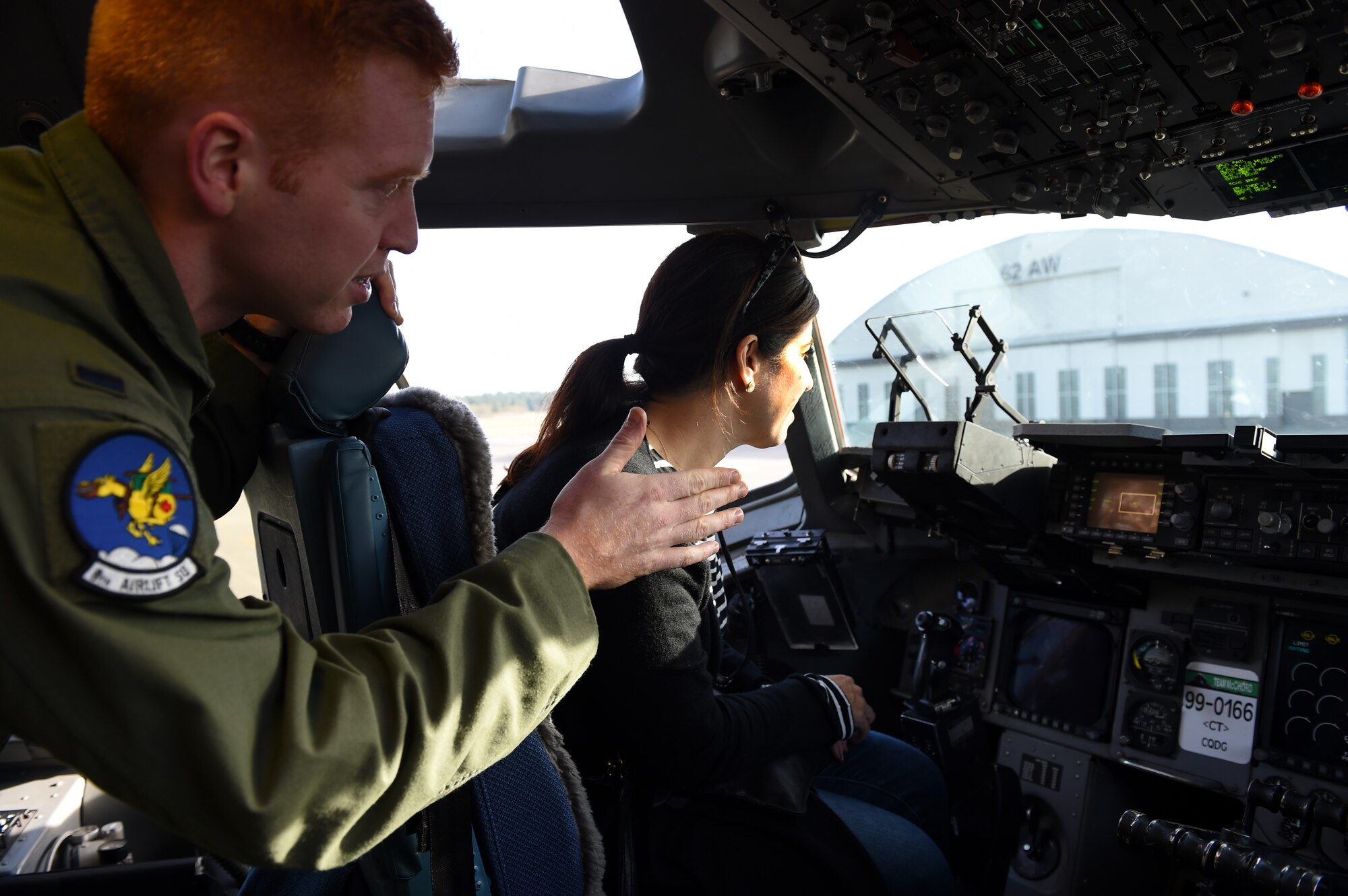 1st Lt. James Jensen, 8th Airlift Squadron C-17 Globemaster III pilot, shows Shauna Swerland, Gen Next member, the cockpit of a C-17 on the McChord Field flight line Oct. 22, 2015 at Joint Base Lewis- McChord, Wash. Gen Next, an organization of individuals dedicated to learning about the most pressing challenges facing future generations, toured JBLM to get a better understanding of the mission and capabilities of the base. (Air Force Photo/Senior Airman Naomi Griego)