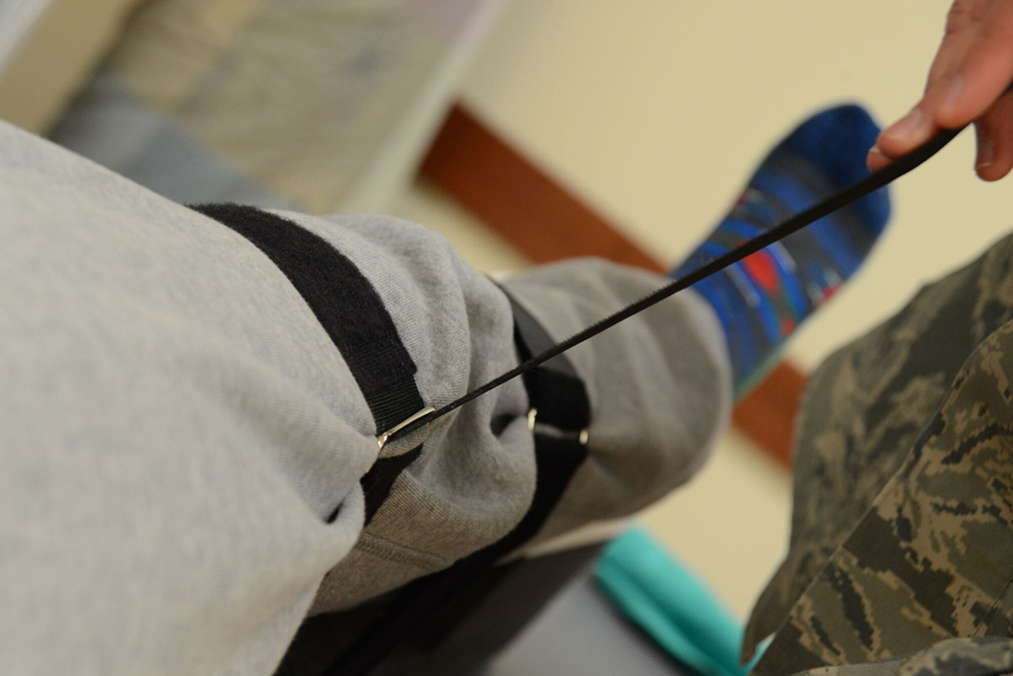 Senior Airman Erik Hayworth, 673d Medical Operations Squadron physical medicine technician, treats Staff Sgt. Constance Vaughn, 773d Civil Engineer Squadron Operations Management, by fastening her acute knee injury at an angle at the physical therapy clinic on Joint Base Elmendorf-Richardson, Alaska, Oct. 14, 2015. The acute care program is opening its doors to all beneficiaries Nov. 6, 2015. The program, part of the physical therapy clinic, responds to acute injuries for quicker treatment. An acute injury is one that isn’t an emergency, but stems from a specific trauma, joint or muscle and can be seen at the acute care clinic at the JBER hospital. (U.S. Air Force photo/Airman 1st Class Christopher R. Morales)