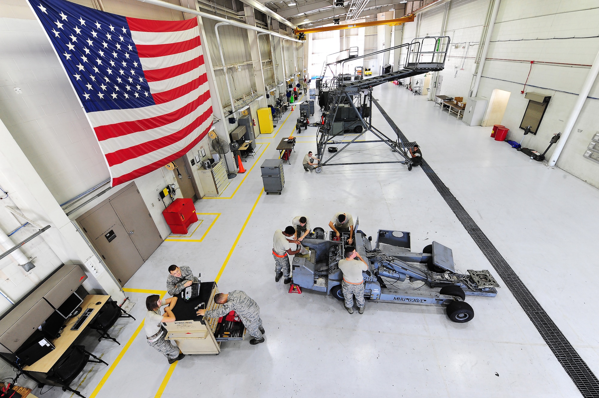 Airmen assigned to the aerospace ground equipment (AGE) shop perform maintenance on a bomb lift at Whiteman Air Force Base, Mo., Oct. 21, 2015. The mission of the AGE shop is to maintain and provide equipment for aircraft support with efficient and timely service. (U.S. Air Force photo by Senior Airman Keenan Berry/Released) 