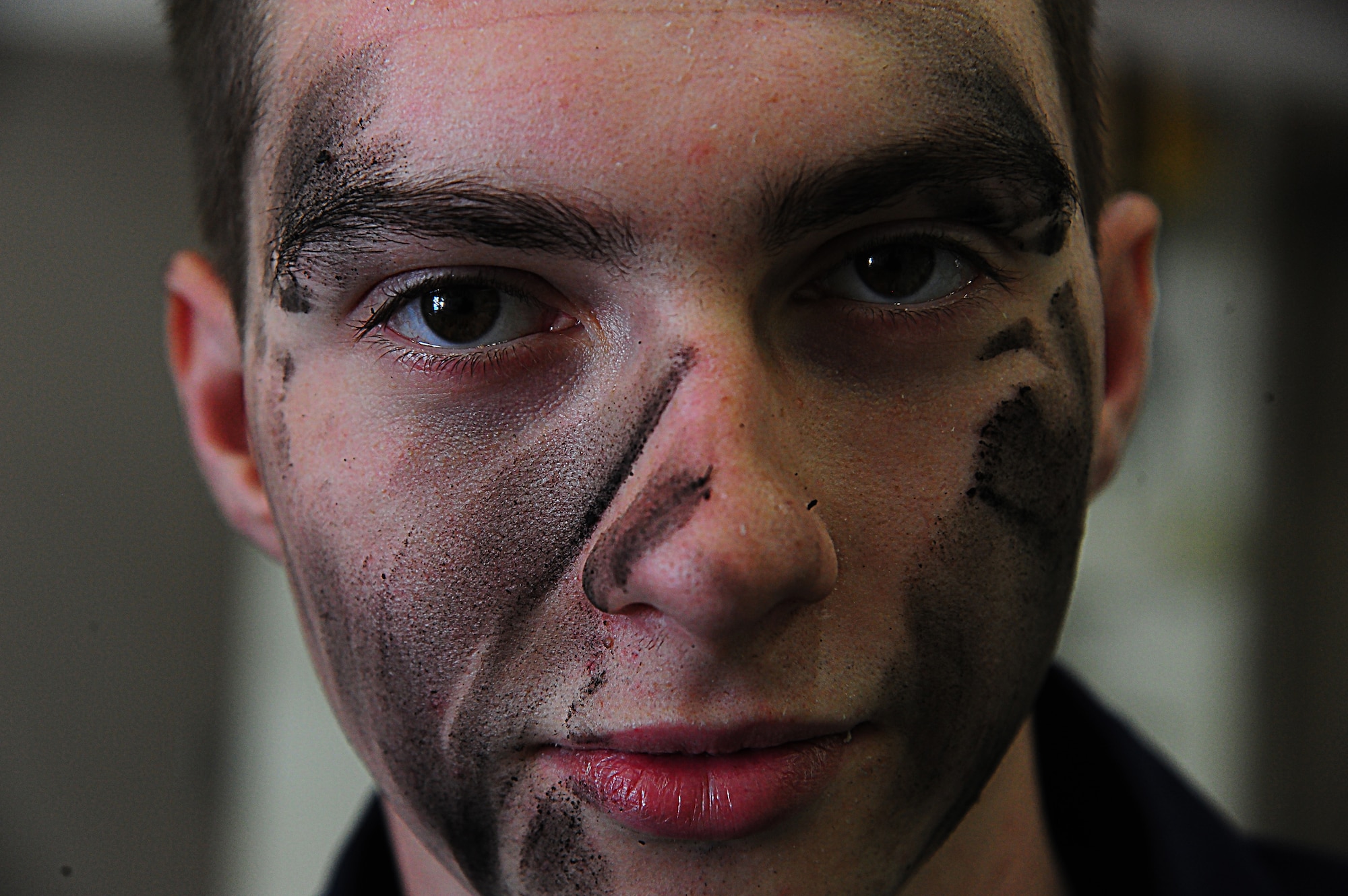 Airman 1st Class Dakota Hurt, 509th Maintenance Squadron aerospace ground equipment journeyman, has grime on his face from repairing the MHU-83 bomb lifter at Whiteman Air Force Base, Mo., Oct. 21, 2015. The shop’s daily mission to repair equipment for aircraft related tasks. (U.S. Air Force photo by Senior Airman Keenan Berry/Released)