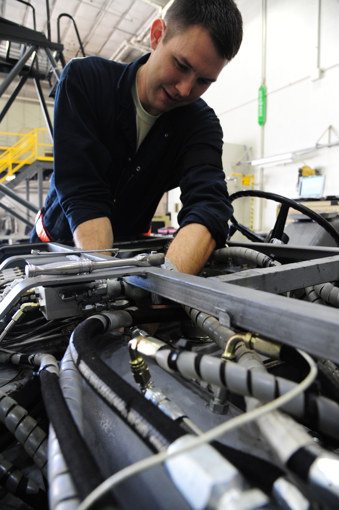 Senior Airman Matthew Bridwell, 509th Maintenance Squadron aerospace ground equipment journeyman, performs a phase II inspection on a hydraulic munitions lift at Whiteman Air Force Base, Mo., Oct. 21, 2015. Phase II inspections are performed as preventive maintenance to repair discrepancies to ensure the equipment is functioning properly.  (U.S. Air Force photo by Senior Airman Keenan Berry/Released)