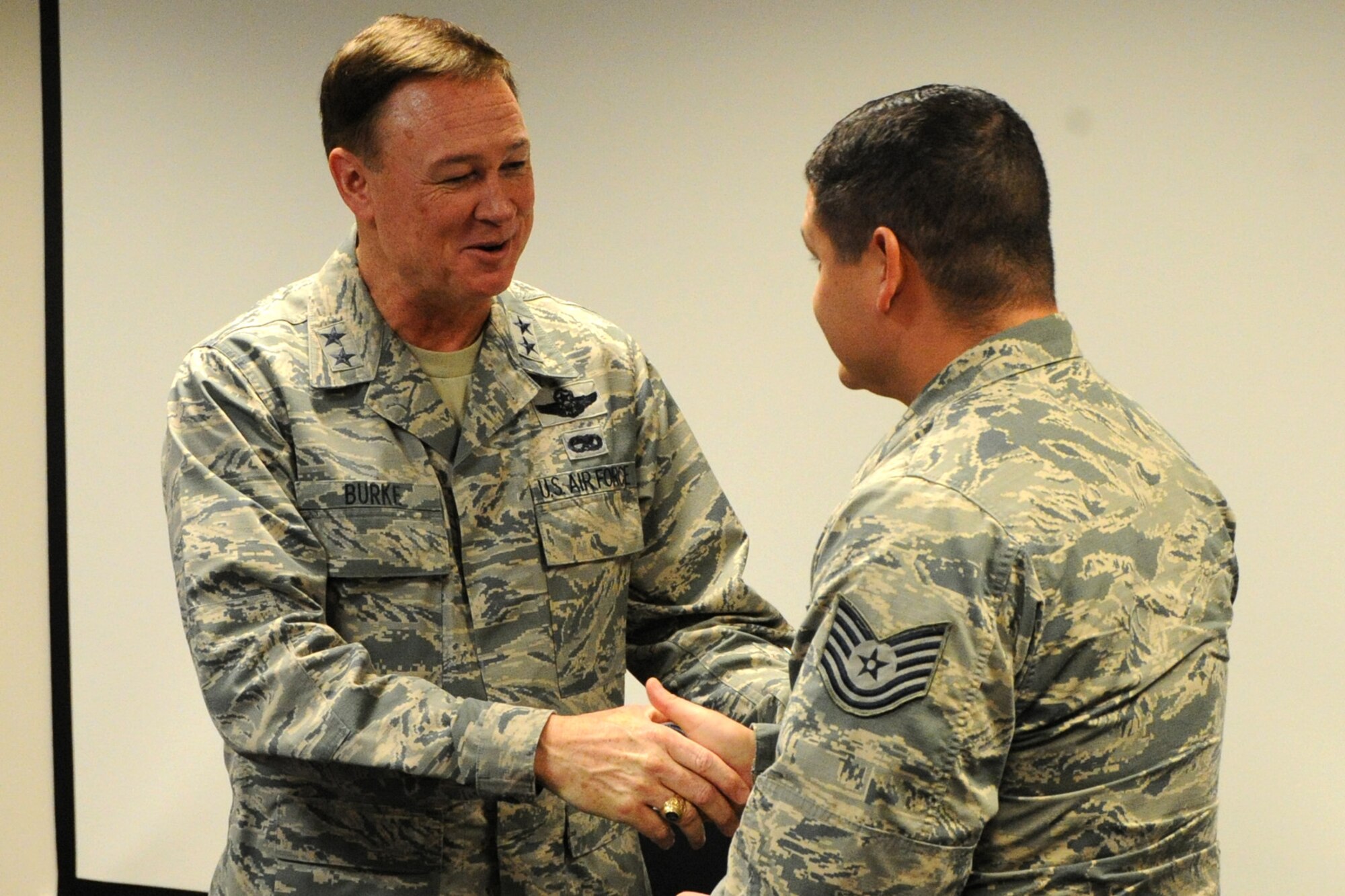 Air Force District of Washington Commander Maj. Gen. Darryl W. Burke coins TSgt Aaron Cantu, 11th Civil Engineer Squadron Explosive Ordnance Disposal journeyman, on Joint Base Andrews, Md., Oct. 23, 2015. Burke communicates his appreciation for the EOD Airmen’s sacrifice for the mission and recognized excellence within their career field. (U.S. Air Force photo/Staff Sgt. Matt Davis)