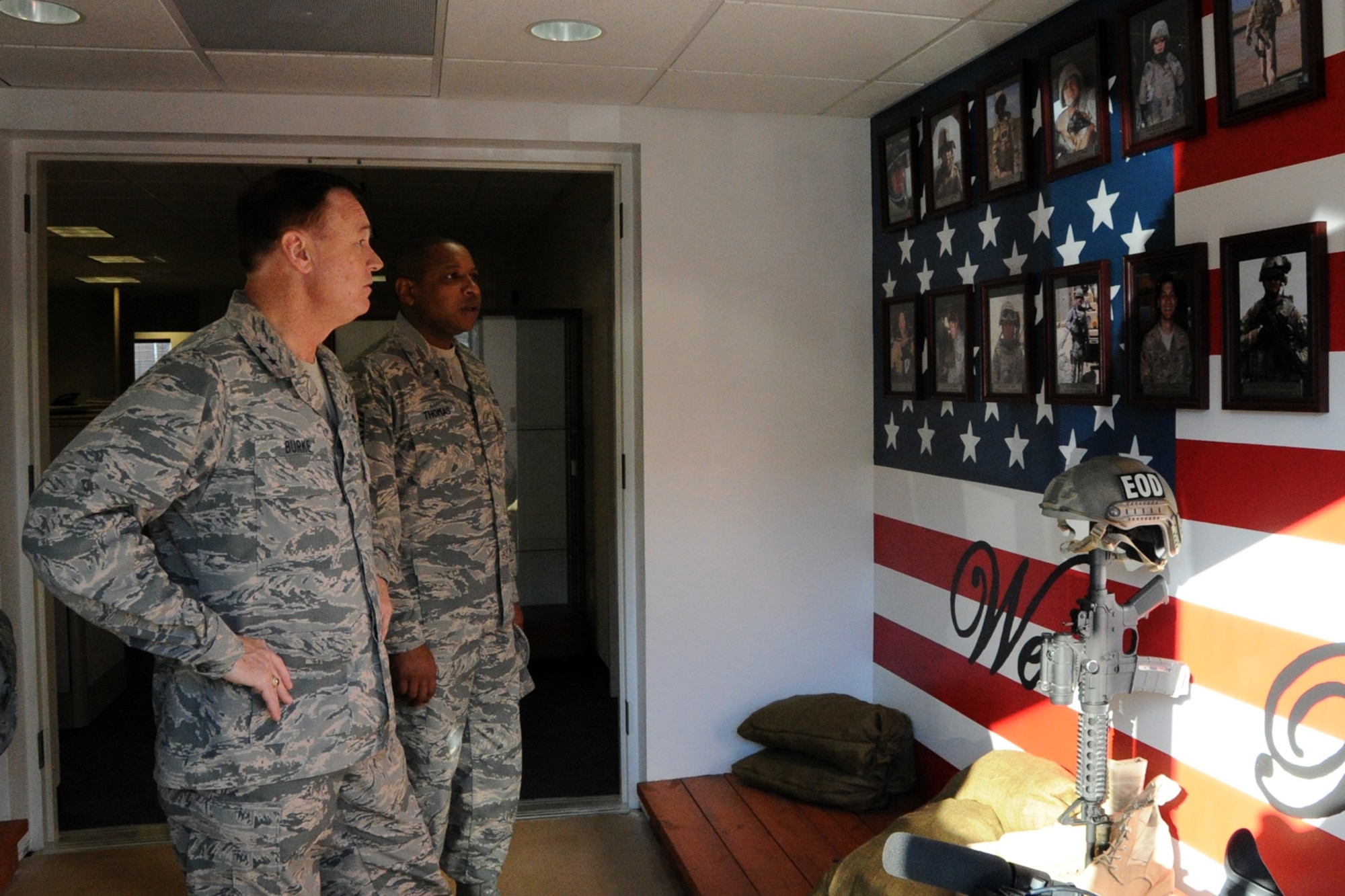 Air Force District of Washington Commander Maj. Gen. Darryl W. Burke and AFDW Command Chief Master Sgt. Farrell Thomas view a wall dedicated to fallen Explosive Ordnance Disposal Airmen on Joint Base Andrews, Md., Oct. 23, 2015. Burke communicates his appreciation for the EOD Airmen’s sacrifice for the mission and recognized excellence within their career field. (U.S. Air Force photo/Staff Sgt. Matt Davis)