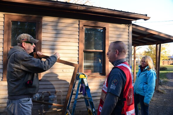 Airmen from Malmstrom Air Force Base and federal employees volunteer to perform household chores and install smoke detectors for the Day of Caring Oct. 23, 2015, in the Great Falls, Mont., community. A total of 300 homes were visited where household chores were performed, with 250 of those homes receiving smoke alarm installations and maintenance. (U.S. Air Force photo/Airman 1st Class Magen M. Reeves)