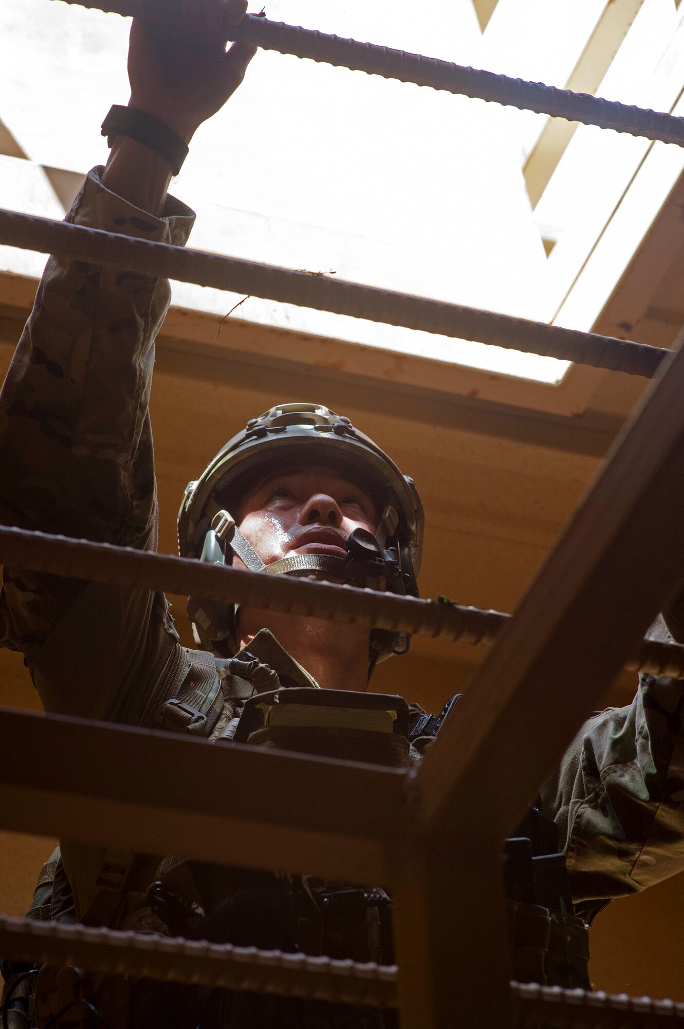 Staff Sgt. Jared Cowart, a joint tactical air controller from the 25th Air Support Operations Squadron, climbs to the top of a tower during a field training exercise on Bellows Air Force Station, Hawaii, Oct. 21, 2015. During the three day FTX, Airmen and Soldiers trained together to sharpen their specific skillsets. The Airmen from the 25th ASOS focused on their abilities to communicate with the Army ground commanders to call in air support from a variety of air to ground assets. The FTX allows military members to deploy to field locations to conduct tactical operations under simulated combat conditions.(U.S. Air Force photo by Tech. Sgt. Aaron Oelrich/Released)