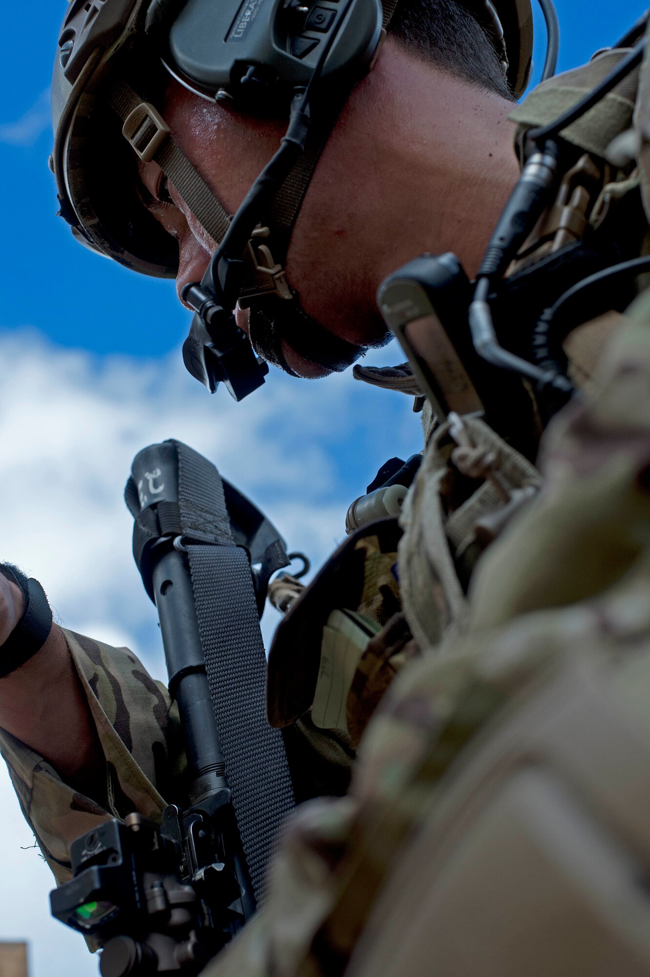 Staff Sgt. Jared Cowart, a joint tactical air controller from the the 25th Air Support Operations Squadron, surveys the target area to identify landmarks that will assist in air to ground targeting operations during a field training exercise on Bellows Air Force Station, Hawaii, Oct. 21, 2015. During the three day FTX, Airmen and Soldiers trained together to sharpen their specific skill sets. The Airmen from the 25th ASOS focused on their ability to communicate with the Army ground commanders to call in air support from a variety of air to ground assets. The FTX allows military members to deploy to field locations to conduct tactical operations under simulated combat conditions.(U.S. Air Force photo by Tech. Sgt. Aaron Oelrich/Released)
