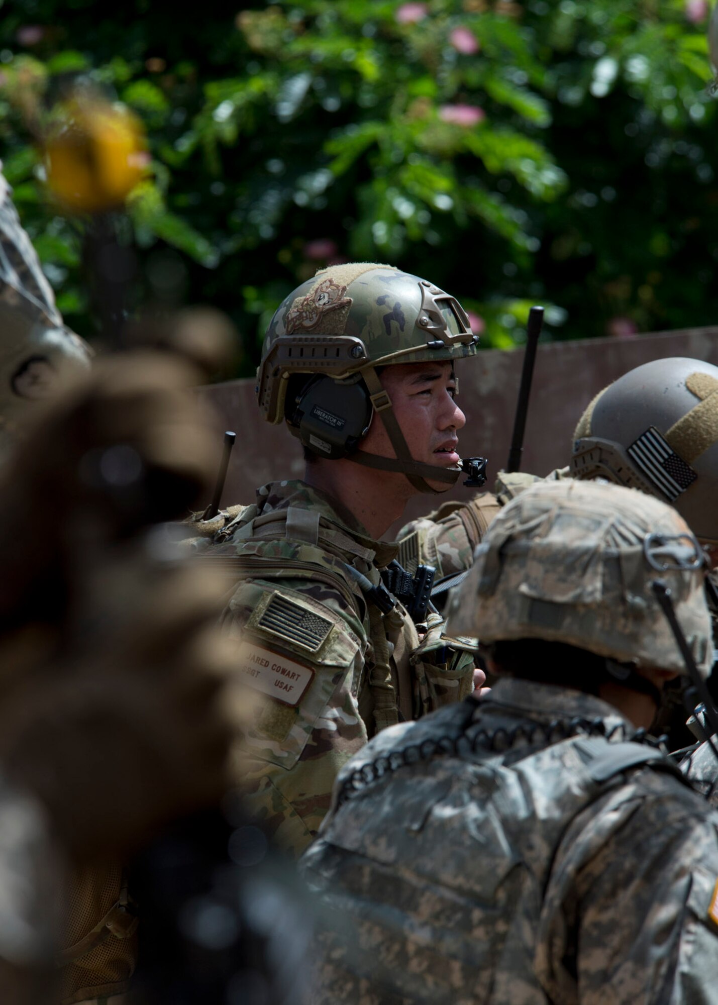 Staff Sgt. Jared Cowart, a joint tactical air controller from the the 25th Air Support Operations Squadron, watches ground troop movements during a field training exercise on Bellows Air Force Station, Hawaii, Oct. 21, 2015. During the three day FTX, Airmen and Soldiers trained together to sharpen their specific skillsets. The Airmen from the 25th ASOS focused on their ability to communicate with the Army ground commanders to call in air support from a variety of air to ground assets. The FTX allows military members to deploy to field locations to conduct tactical operations under simulated combat conditions.(U.S. Air Force photo by Tech. Sgt. Aaron Oelrich/Released)