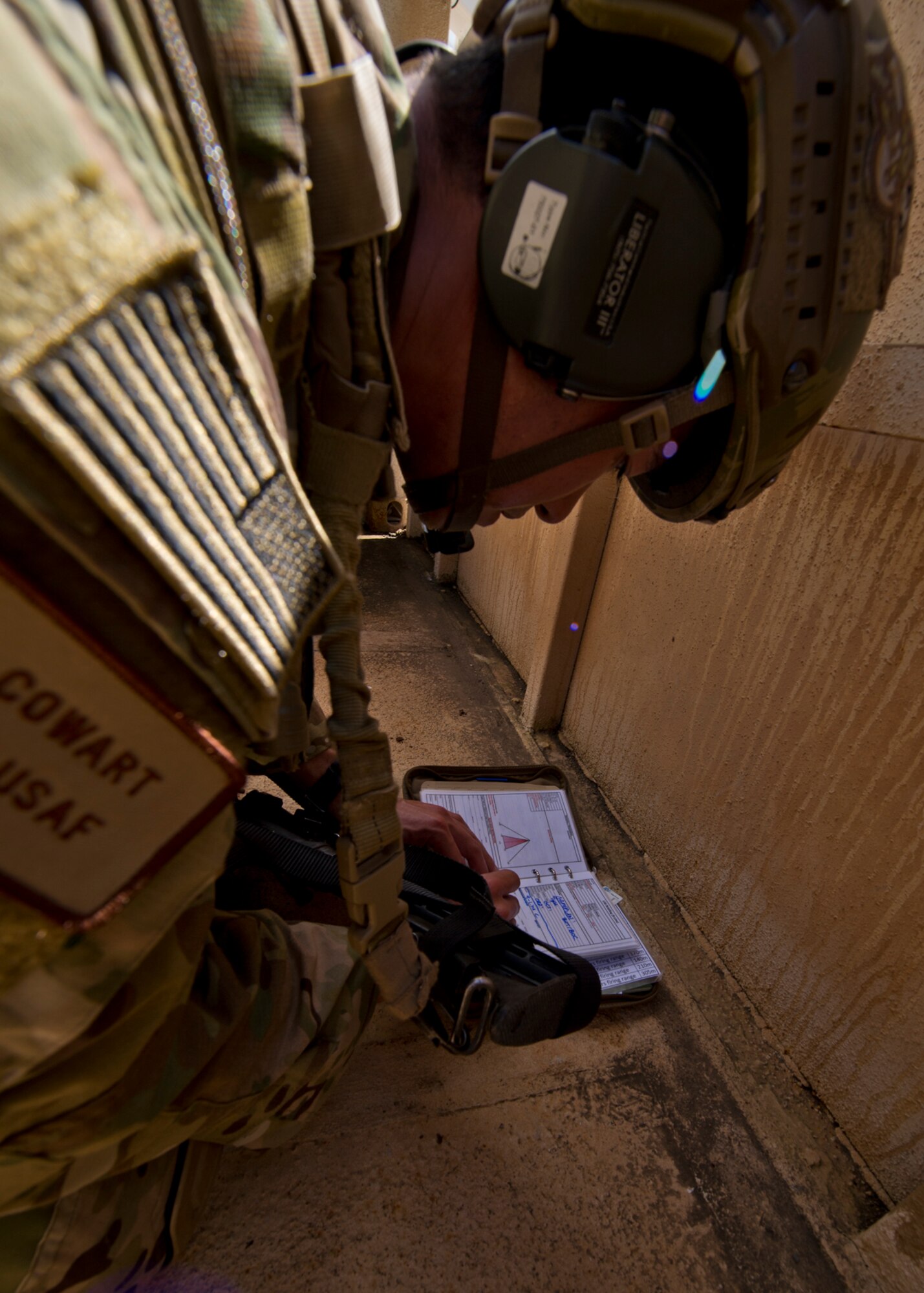 taff Sgt. Jared Cowart, a joint tactical air controller from the 25th Air Support Operations Squadron, writes down information that will be used to identify the ground target to air support during a field training exercise on Bellows Air Force Station, Hawaii, Oct. 20, 2015. During the three day FTX Airmen and Solders trained together to sharpen their specific skill sets. The Airmen from the 25th ASOS focused on their ability to communicate with the Army ground commanders to call in air support from a variety of air to ground assets. The FTX allows military members to deploy to field locations to conduct tactical operations under simulated combat conditions. (U.S. Air Force photo by Tech. Sgt. Aaron Oelrich/Released)