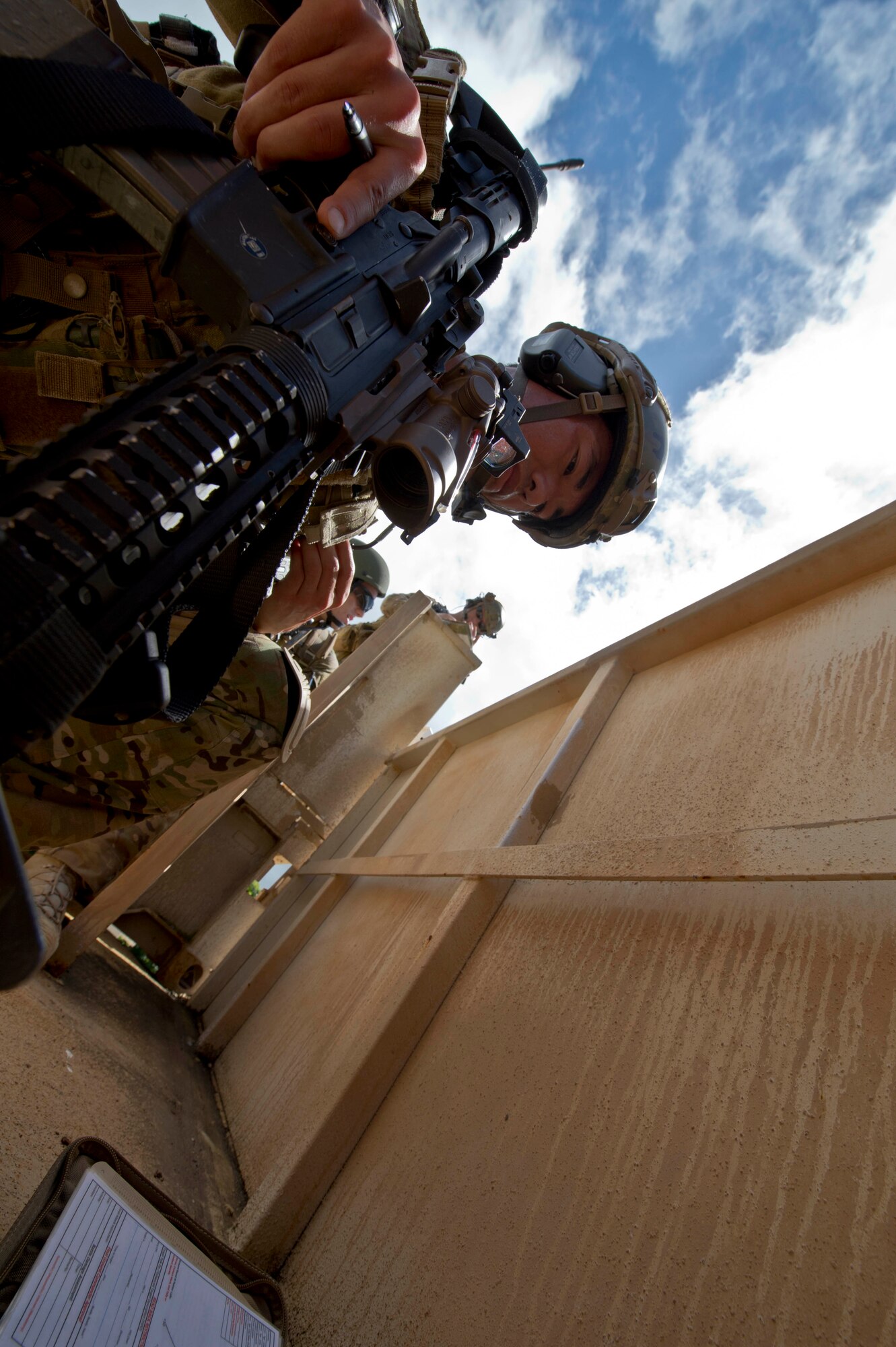 Staff Sgt. Jared Cowart, a joint tactical air controller from the 25th Air Support Operations Squadron, identifies where friendly forces are moving and looks for opposition force locations during a field training exercise on Bellows Air Force Station, Hawaii, Oct. 21, 2015. The FTX was a combined training opportunity for Airmen from the 25th ASOS and Soldiers from the 25th Infantry Division to train together and interact as they would in a deployed location. The Airmen from the 25th ASOS focused on their ability to communicate with the Army ground commanders to call in air support from a variety of air to ground assets. The FTX allows military members to deploy to field locations to conduct tactical operations under simulated combat conditions. (U.S. Air Force photo by Tech. Sgt. Aaron Oelrich/Released)