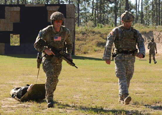 A Green Beret assigned to the 7th Special Forces Group (Airborne) drags a litter bearing a mannequin weighing 210 lbs. to the finish line of a stress shoot competition held Oct. 15 at Eglin Air Force Base, Fla. The competition tested the Special Forces Soldier's ability to navigate terrain and obstacles while engaging targets accurately despite his elevated heart rate and rapid breathing.  (Photo by Staff Sgt. William Waller)