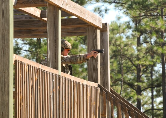 A Green Beret assigned to the 7th Special Forces Group (Airborne) engages targets from an elevated firing position during a stress shoot competition held Oct. 15 at Eglin Air Force Base, Fla. The competition tested the Special Forces Soldier's ability to navigate terrain and obstacles while engaging targets accurately despite his elevated heart rate and rapid breathing.  (Photo by Staff Sgt. William Waller)
