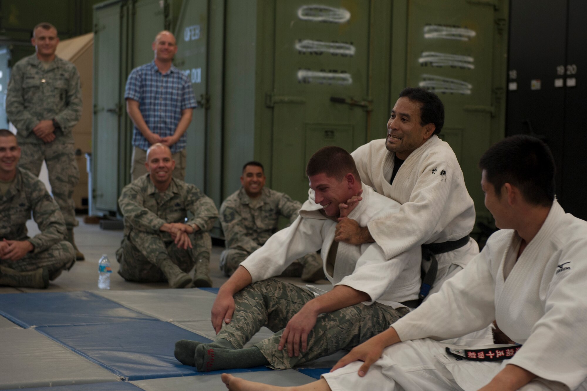 Kei Toguchi, Okinawa Police Station foreign case investigator, first criminal investigator section, performs Judo techniques on Staff Sgt. Michael Starkovich, 18th Security Forces Squadron armory NCO in charge, during the Inaugural Law Enforcement Officer Exchange Oct. 22, 2015, on Kadena Air Base, Japan. The exchange allowed Kadena’s law enforcement to see some of the tactics used by the Okinawan police. (U.S. Air Force photo by Airman 1st Class Lynette M. Rolen)