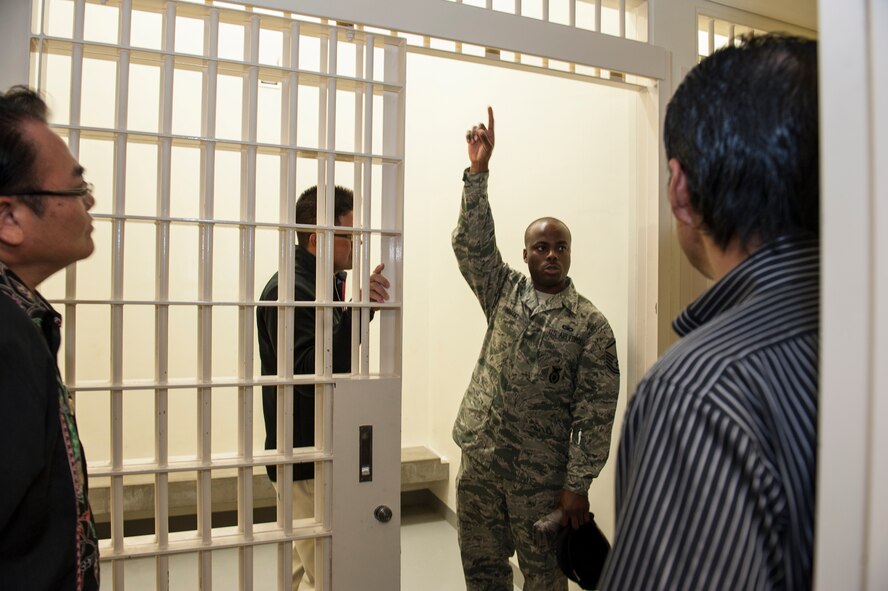 U.S. Air Force Master Sgt. Tony Bostic, 18th Security Forces Squadron flight operations superintendent, explains the properties of Kadena’s holding cells to Okinawa Police Station members during the Inaugural Law Enforcement Officer Exchange Oct. 22, 2015, on Kadena Air Base, Japan. Okinawan police were able to see what security measures are implemented in order to protect Kadena’s members. (U.S. Air Force photo by Airman 1st Class Lynette M. Rolen)