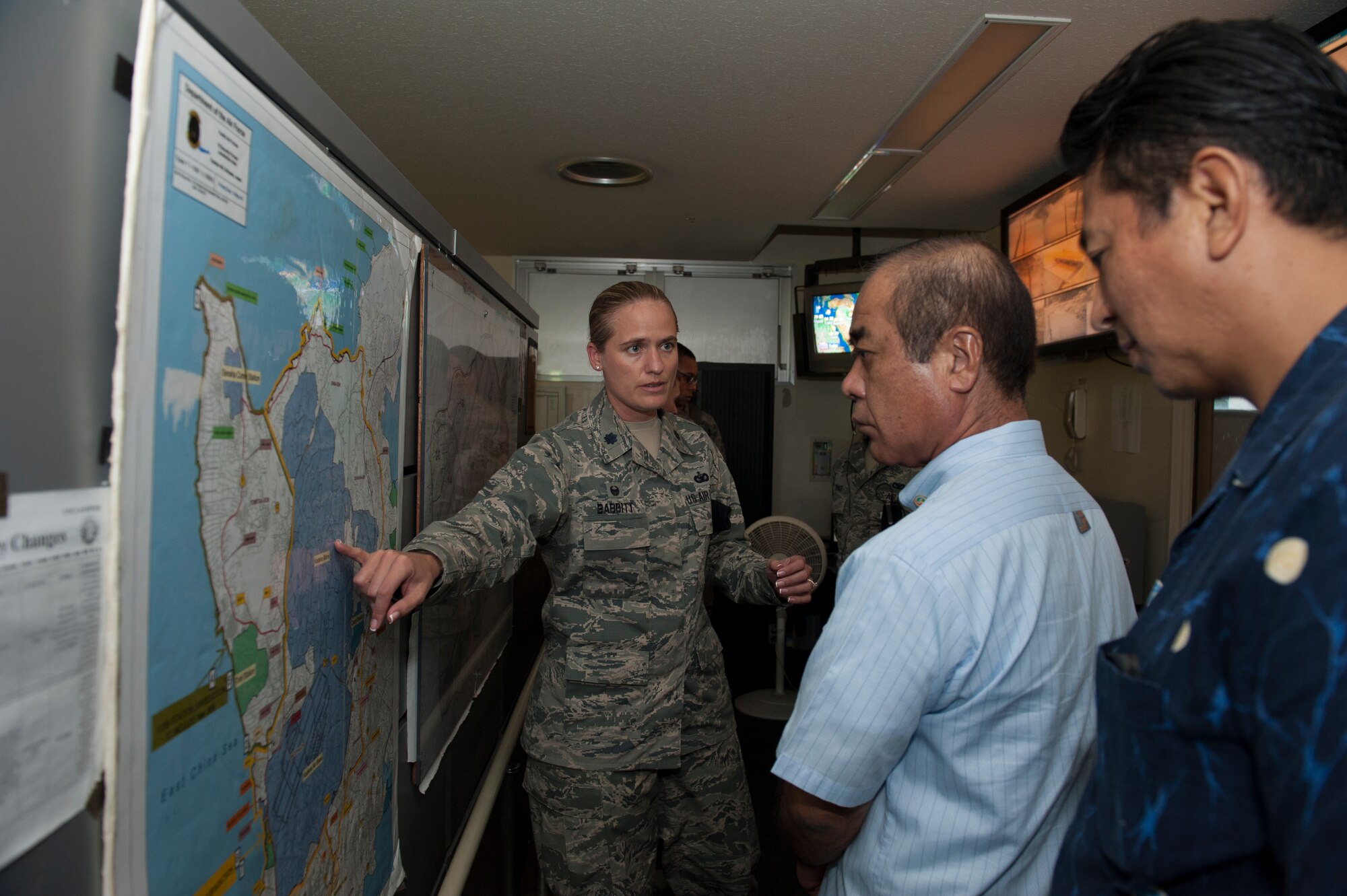 U.S. Air Force Lt. Col. Sarah Babbitt, 18th Security Forces Squadron commander, explains a jurisdiction map to Hajime Shinzato, Chief of Okinawa Police Station and Kazumune Namizato, Okinawa Police Station senior foreign case investigator, during the Inaugural Law Enforcement Officer Exchange Oct. 22, 2015, on Kadena Air Base, Japan. The map displays where our military forces have authority on Okinawa. (U.S. Air Force photo by Airman 1st Class Lynette M. Rolen)