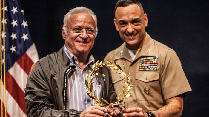 Christos Panagopoulos, Ambassador of Greece, and Col. Joseph M. Murray, commander, Marine Corps Installations National Capital Region-Marine Corps Base Quantico, show one of the wreaths that will be presented to winners of the Marine Corps Marathon during the press conference for the 40th Marine Corps Marathon at the National Press Club in Washington, Oct. 20.The wreaths, which were made in Marathon, Greece, will be awarded to the top 3 male and female winners.