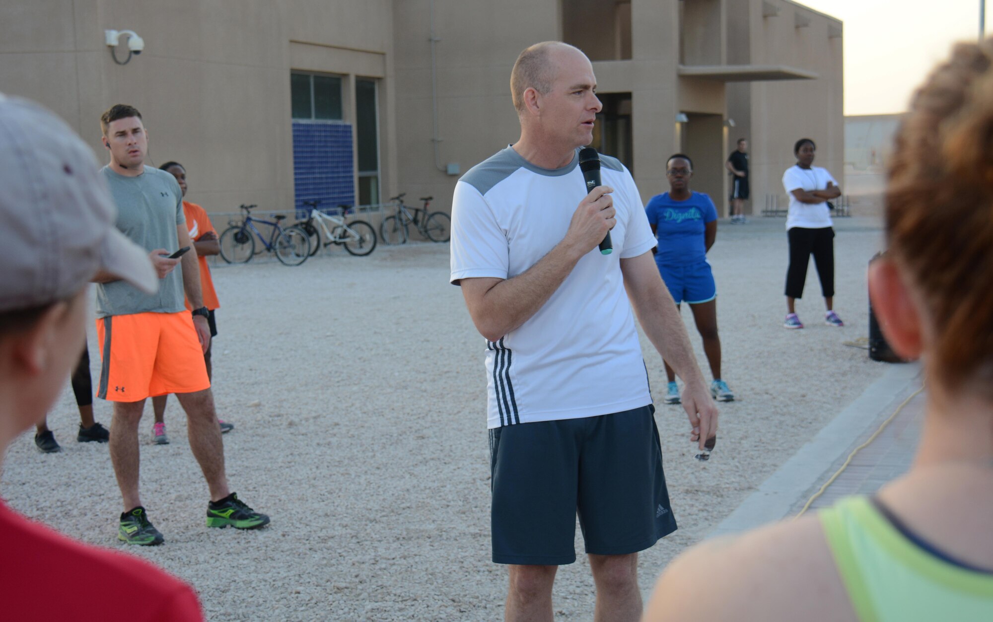 Brig. Gen. Darren James, 379th Air Expeditionary Wing commander, welcomes runners to the Dignity and Respect 5K Oct. 23, 2015 at Al Udeid Air Base, Qatar. The general said it's important for everyone to be treated with respect and thanked everyone in attendance for showing their support. More than 150 people participated in the 3.1 mile race. (U.S. Air Force photo by Tech. Sgt. James Hodgman/Released)