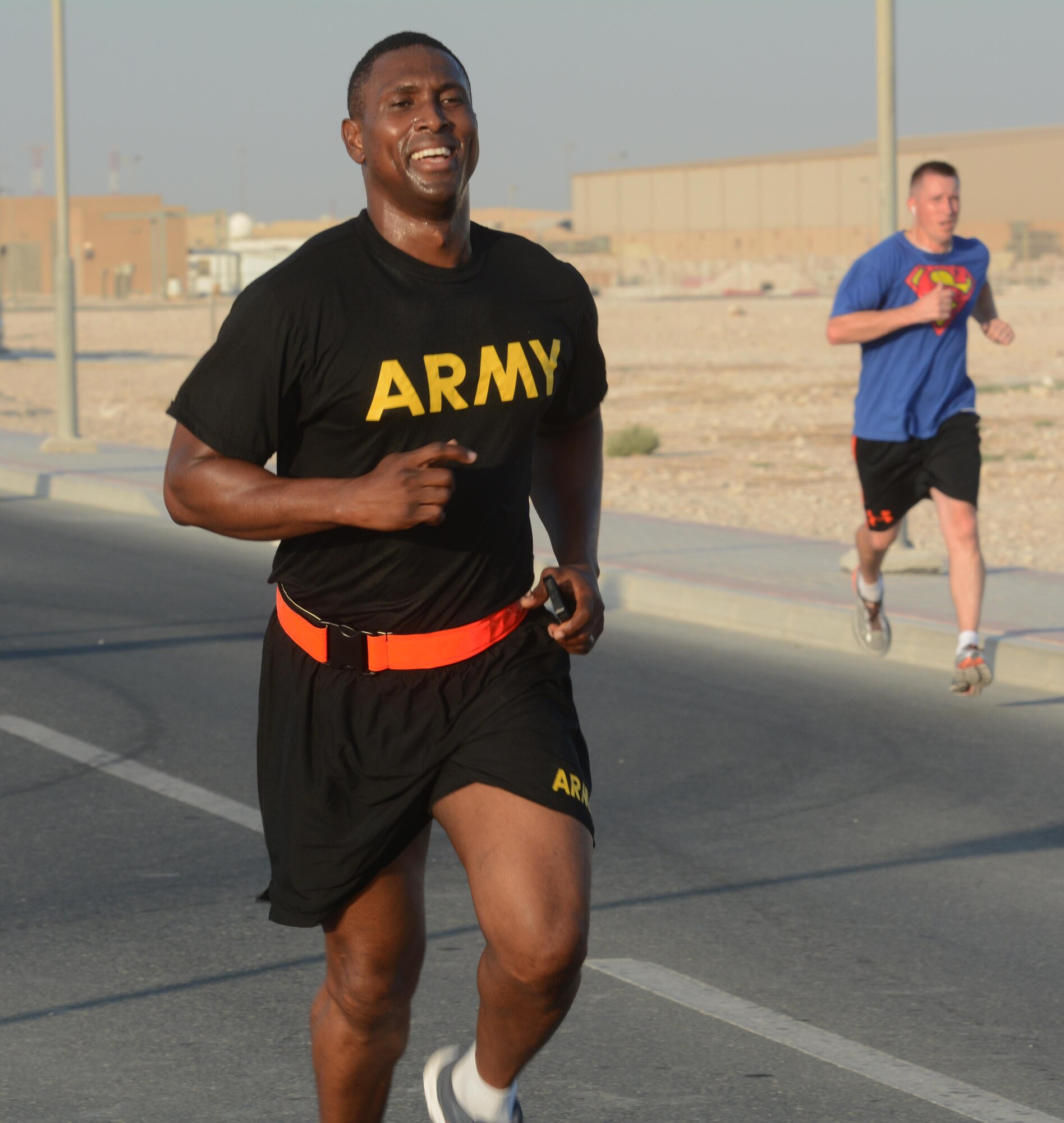 U.S. Army Capt. Maxwell Babjide, 31st Air Defense Artillery Brigade, runs to the finish line of the Dignity and Respect 5K at Al Udeid Air Base, Qatar Oct. 23, 2015. The 3.1 mile race was organized to foster a culture of dignity and respect among service members.  (U.S. Air Force photo by Tech. Sgt. James Hodgman/Released)