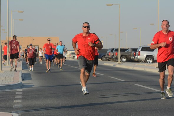 Runners race to the finish line of the Dignity and Respect 5K Oct. 23, 2015 at Al Udeid Air Base, Qatar. The 3.1 mile race was organized to foster a culture of dignity and respect among service members. (U.S. Air Force photo by Tech. Sgt. James Hodgman/Released)
