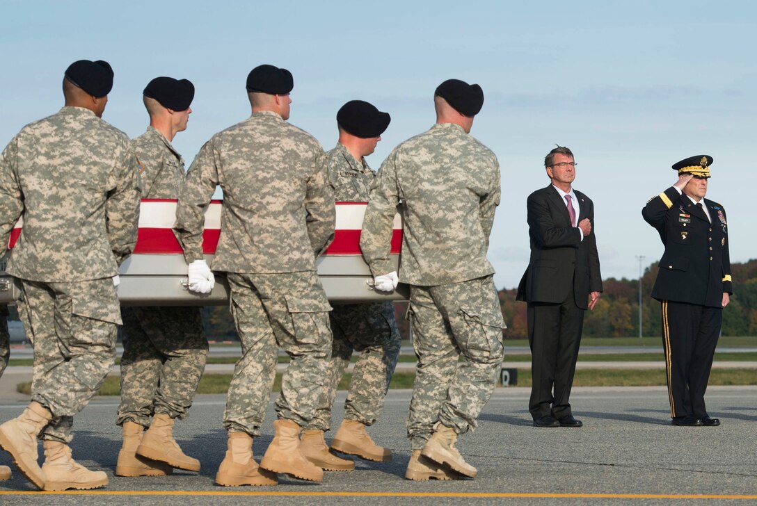 Defense Secretary Ash Carter and Army Chief of Staff Gen. Mark A. Milley render honors as an Army carry team moves the transfer case of U.S. Army Master Sgt. Joshua L. Wheeler during the dignified transfer of his remains at Dover Air Force Base, Del., Oct. 24, 2015. Secretary Carter attended the ceremony to pay his respects to the fallen soldier. DoD photo by Air Force Senior Master Sgt. Adrian Cadiz