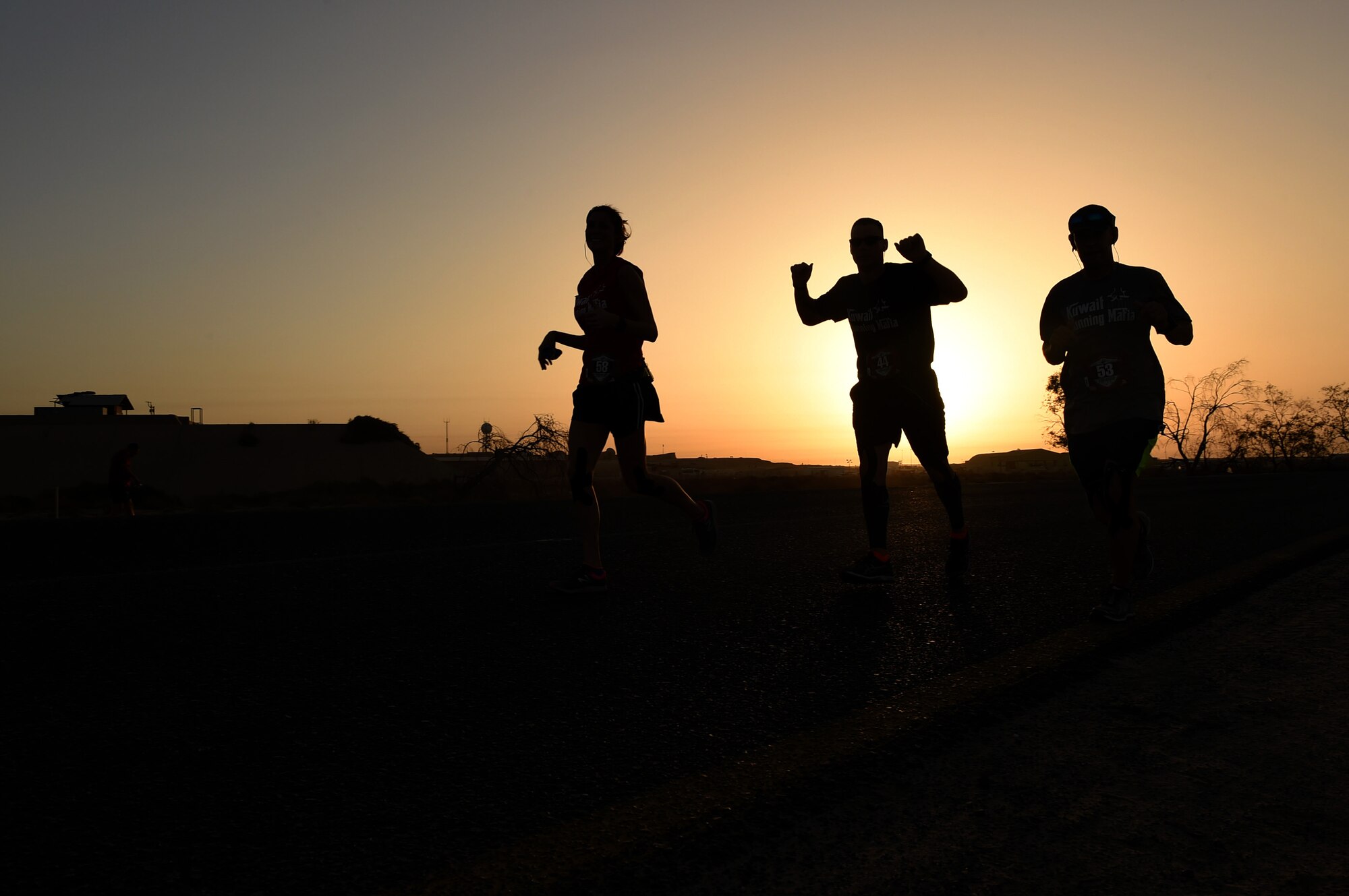 Military service members cheer as they approach the half-way point of the 40th Annual U.S. Marine Corps Marathon-Forward at an undisclosed location in Southwest Asia, Oct. 25, 2015. The official marathon which was held in Virginia and Washington D.C., began in October 1975 and aims to promote physical fitness as well as foster goodwill in the community and showcase the organizational skills of the U.S. Marine Corps. (U.S. Air Force photo by Staff Sgt. Jerilyn Quintanilla/Released) 