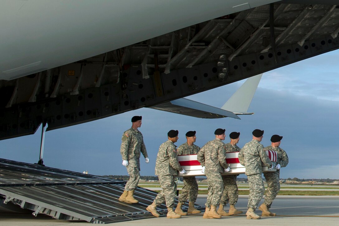 An Army carry team moves the transfer case of U.S. Army Master Sgt. Joshua L. Wheeler during the dignified transfer of his remains at Dover Air Force Base, Del., Oct. 24, 2015. DoD photo by Air Force Senior Master Sgt. Adrian Cadiz