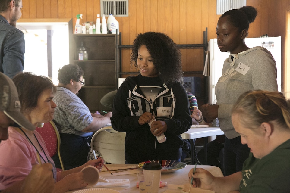 Pfc. Ieesha Gillison and Pfc. Kayla Young, ammunition technicians, Center Magazine Area, help Desert Arc Sports and Recreation campers paint bisque ware at Camp Ronald McDonald, Idyllwild, Calif., Oct. 3, 2015. (Official Marine Corps photo by Lance Cpl. Thomas Mudd/ Released)