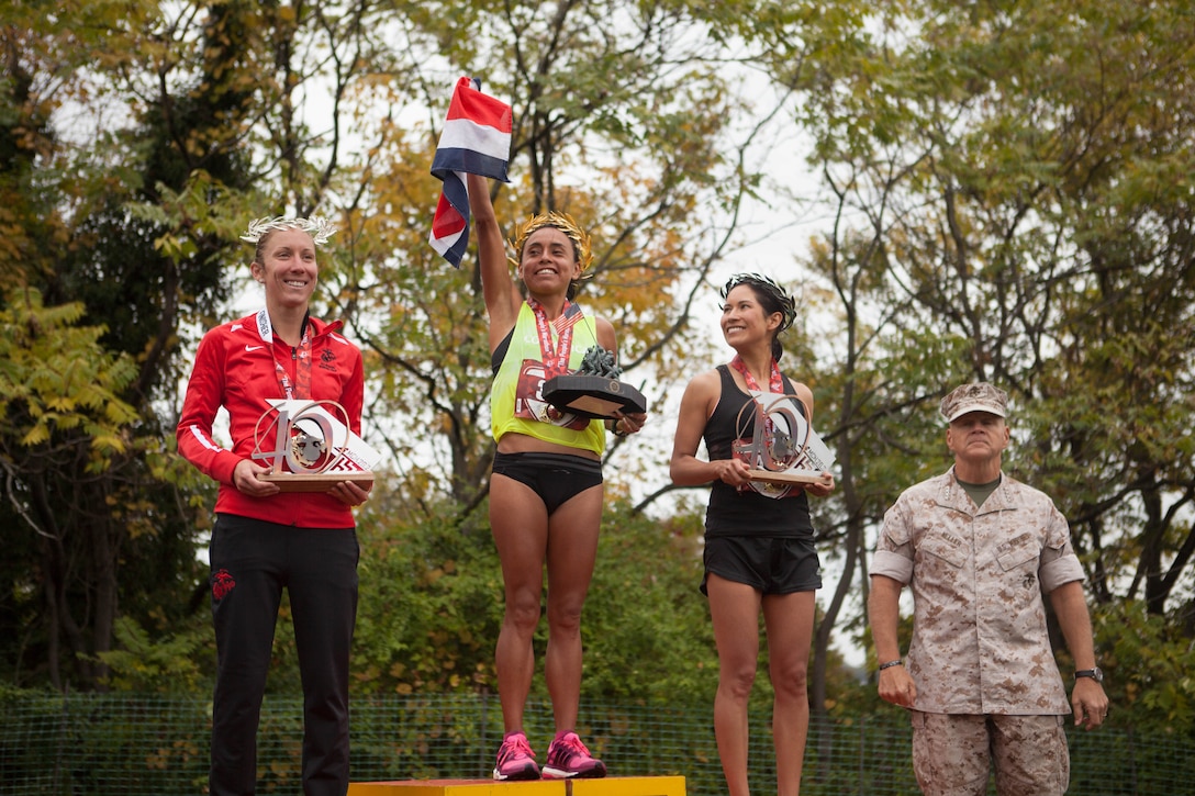 Gen. Robert Neller, the 37th Commandant of the Marine Corps, stands with the top female finishers of the 40th Marine Corps Marathon in Arlington, Virginia, Oct. 25, 2015. The top three male and female finishers each received a medal, a trophy and a wreath, which was made in Marathon, Greece. This year’s participants joined the 512,370 runners, who have completed the “Marathon of the Monuments” since its inaugural event in 1976.