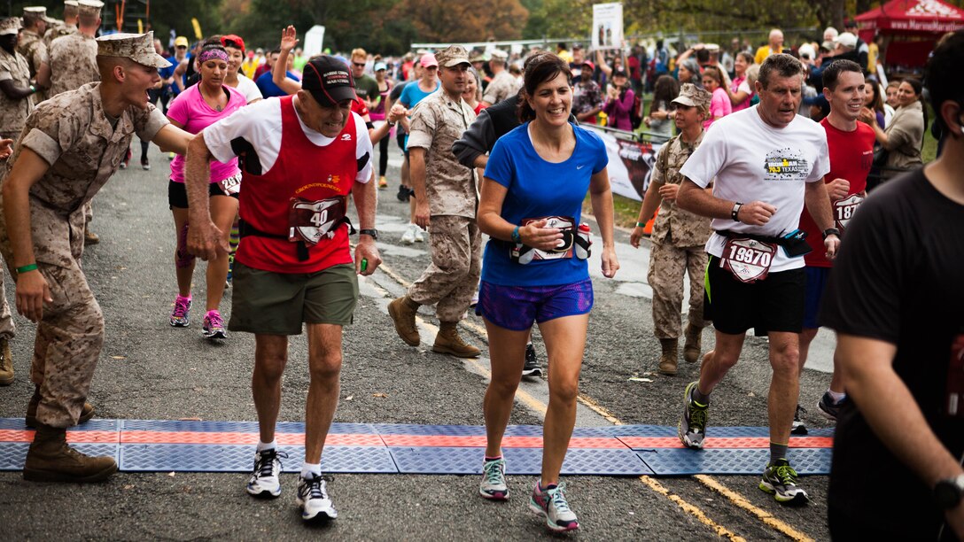 Marine Col. (ret) Al Richmond, center-left, one of the two final “Groundpounders,” completes the 40th Marine Corps Marathon at Arlington, Virginia, Oct. 25, 2015. Richmond has completed every marathon since its inaugural event in 1976.