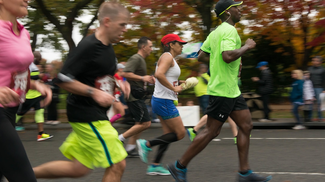 Runners race through Washington during the Marine Corps Marathon, Oct. 25, 2015. More than 30,000 runners dashed 26.2 miles through Washington and Arlington, Virginia, during this year’s race, which marked the 40th running of the “The Peoples Marathon.”