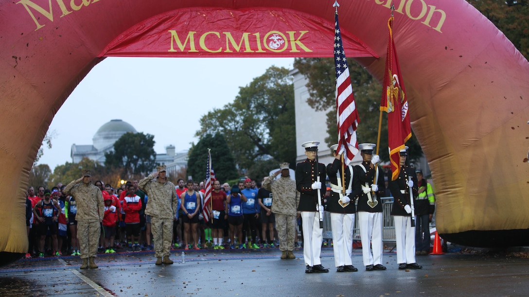 A color guard from Marine Corps Base Quantico High School JROTC presents the colors prior to the start of the Marine Corps Marathon 10K race, Oct. 25, 2015, in Washington. More than 10,000 runners participated in the 10-kilometer race as part of the Marine Corps Marathon event, with more than 30,000 participants running the 26.2-mile marathon. 