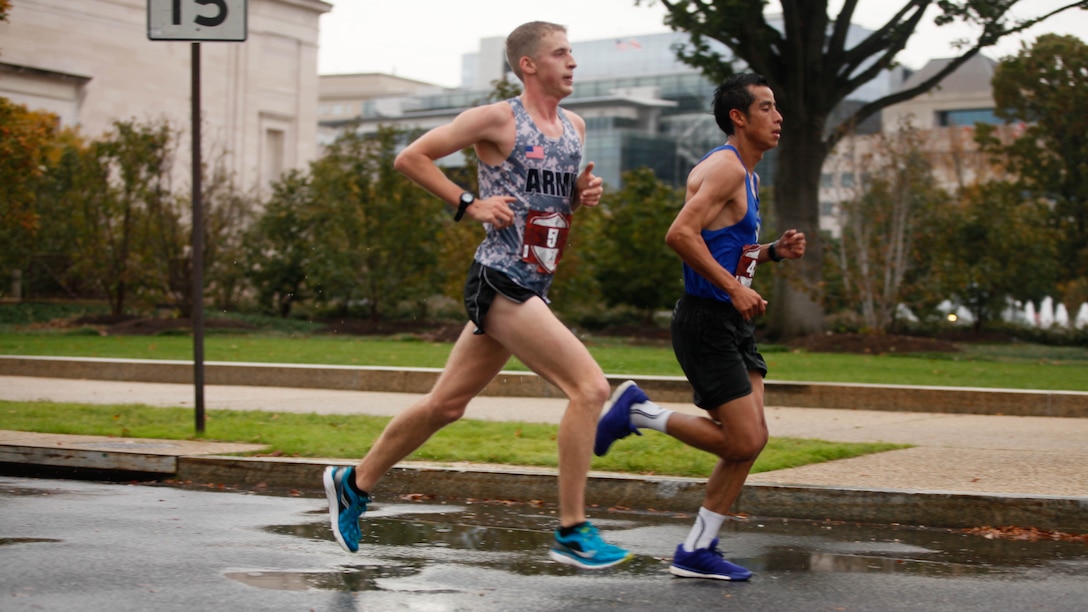 Oscar Mateo Santos, right, and Trevor Lafontaine, run through the National Mall in Washington during the 40th Marine Corps Marathon, Oct. 25, 2015 More than 30,000 came to run in the event. Lafontaine finished in first place with a winning time of 2:24.25, followed by Santos with a time of 2:26.08. 