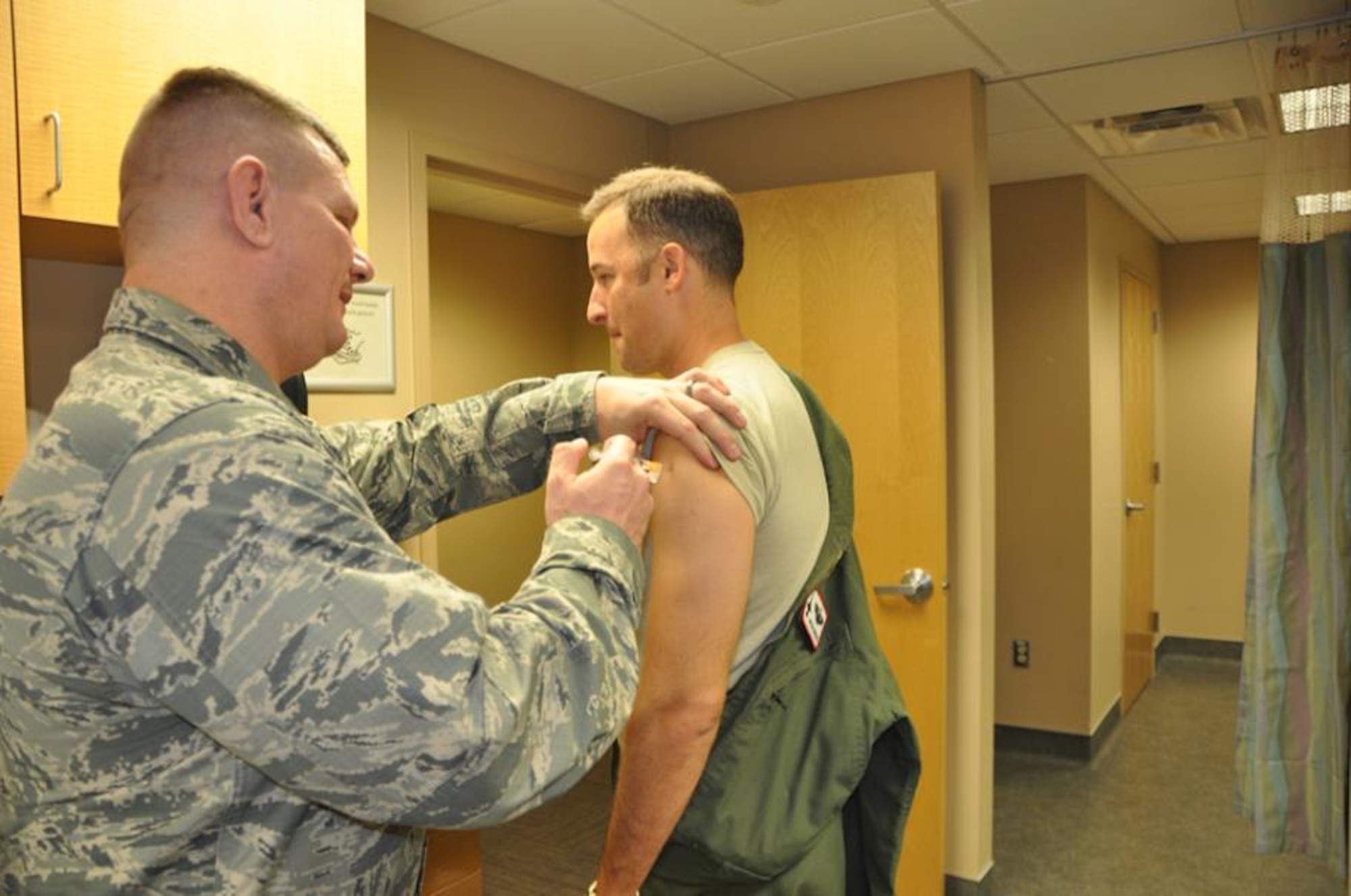 Maj Wyckliffe Furcron, 69th Fighter Squadron pilot and Active Guard Reserve, who flies with the 309th Fighter Squadron receives his annual flu shot from 1st Lt. Shawn O’Haver, 944th Medial Squadron Officer-In-Charge of Immunization and emergency room nurse.  According to O’Haver during the winter months emergency room visits increase by 50 percent due to flu and flu like symptoms and if he had anything to do with it 100 percent of the population would get an annual flu shot. (U.S. Air Force photo taken by Tech. Sgt. Barbara Plante)