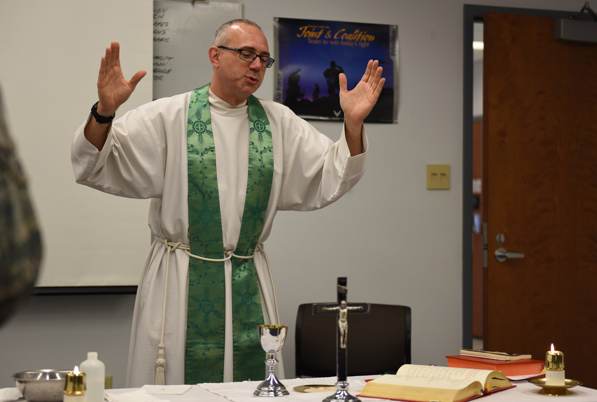 Father John B. Bateman, 193rd Special Operations Wing, Middletown, Pennsylvania, conducts a Catholic mass given to the attending members during October unit training assembly on base. The 193rd offers a variety of religious services for Airmen to attend. (U.S. Air National Guard photo by Senior Airman Ethan Carl/Released)