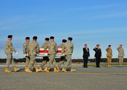 A U.S. Army carry team transfers the remains of Master Sgt. Joshua L. Wheeler of Roland, Okla., during a dignified transfer Oct. 24, 2015, at Dover Air Force Base, Del. Wheeler was assigned to Headquarters U.S. Army Special Operations Command, Fort Bragg, N.C. (U.S. Air Force photo/Senior Airman William Johnson) 

