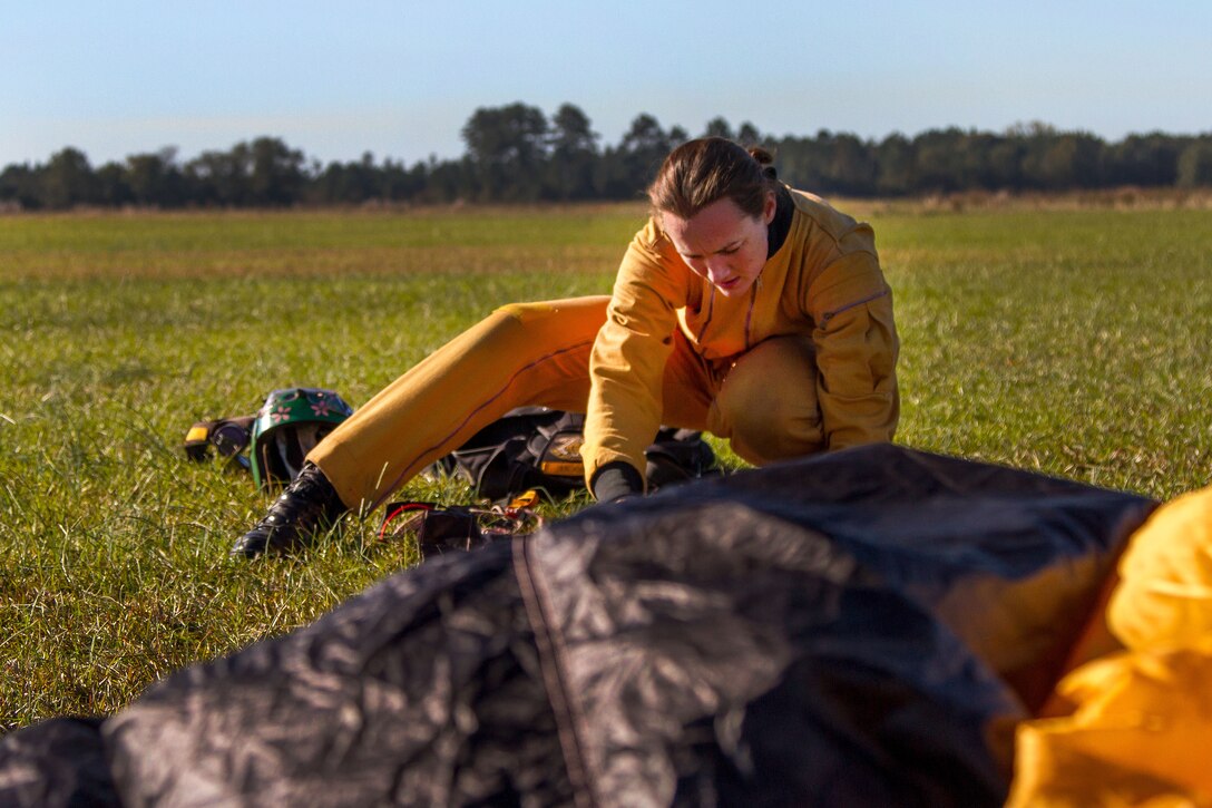 Army Sgt. Shana Greene repacks her parachute after performing a precision landing in Laurinburg, N.C., Oct. 20, 2015. She is a candidate trying out for the U.S. Army Parachute Team the Golden Knights. U.S. Army photo by Staff Sgt. David Meyer