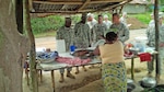 Michigan Army National Guard Soldiers sample local cuisine while on a staff assistance visit to Monrovia, Liberia, Sept. 25, 2015. The Michigan Soldiers will deploy to Liberia in October for one year to support Operation Onward Liberty, a United States Africa Command defense sector reform initiative developed to facilitate implementation of the Liberian National Defense Act by creating a responsible, operationally capable military. 