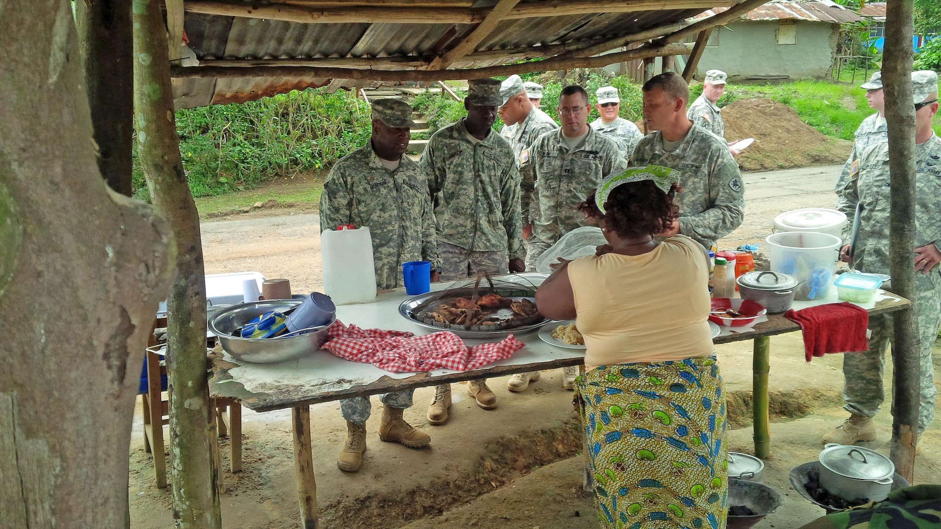 Michigan Army National Guard Soldiers sample local cuisine while on a staff assistance visit to Monrovia, Liberia, Sept. 25, 2015. The Michigan Soldiers will deploy to Liberia in October for one year to support Operation Onward Liberty, a United States Africa Command defense sector reform initiative developed to facilitate implementation of the Liberian National Defense Act by creating a responsible, operationally capable military. 