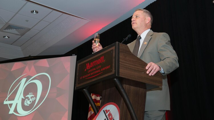 Rick Nealis, race director for the Marine Corps Marathon, toasts to the most recent inductees to the Marine Corps Hall of Fame during the Marine Corps Hall of Fame dinner and ceremony at the Hyatt Regency Reagan National Airport in Crystal City, Va., Oct. 23, 2015. Chas Henry and Jeff Galloway were inducted for their respective contributions to the marathon over the years.